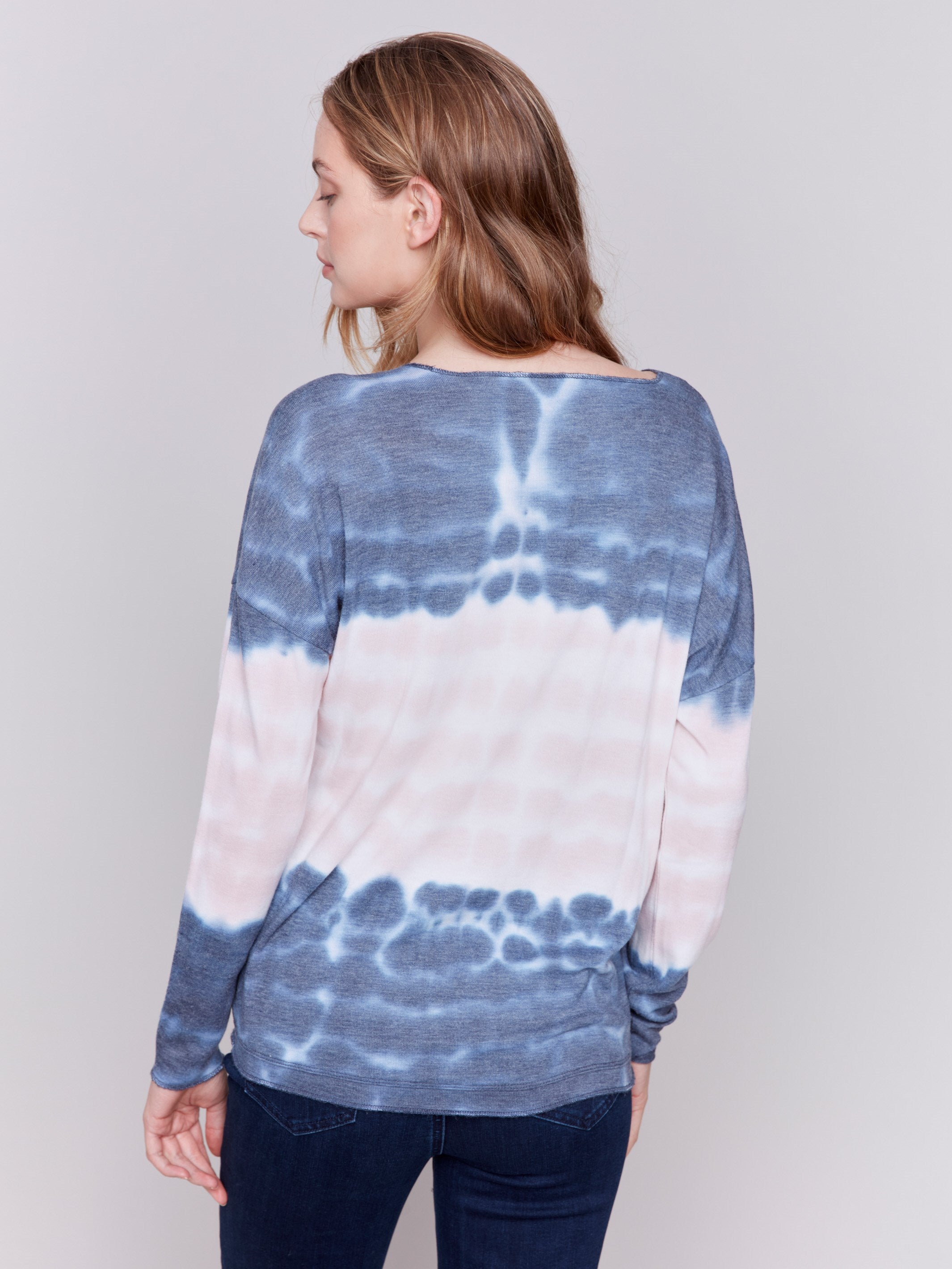 Long-sleeve V-neck knit top with a unique tie-dye wave pattern in blue by Charlie B.