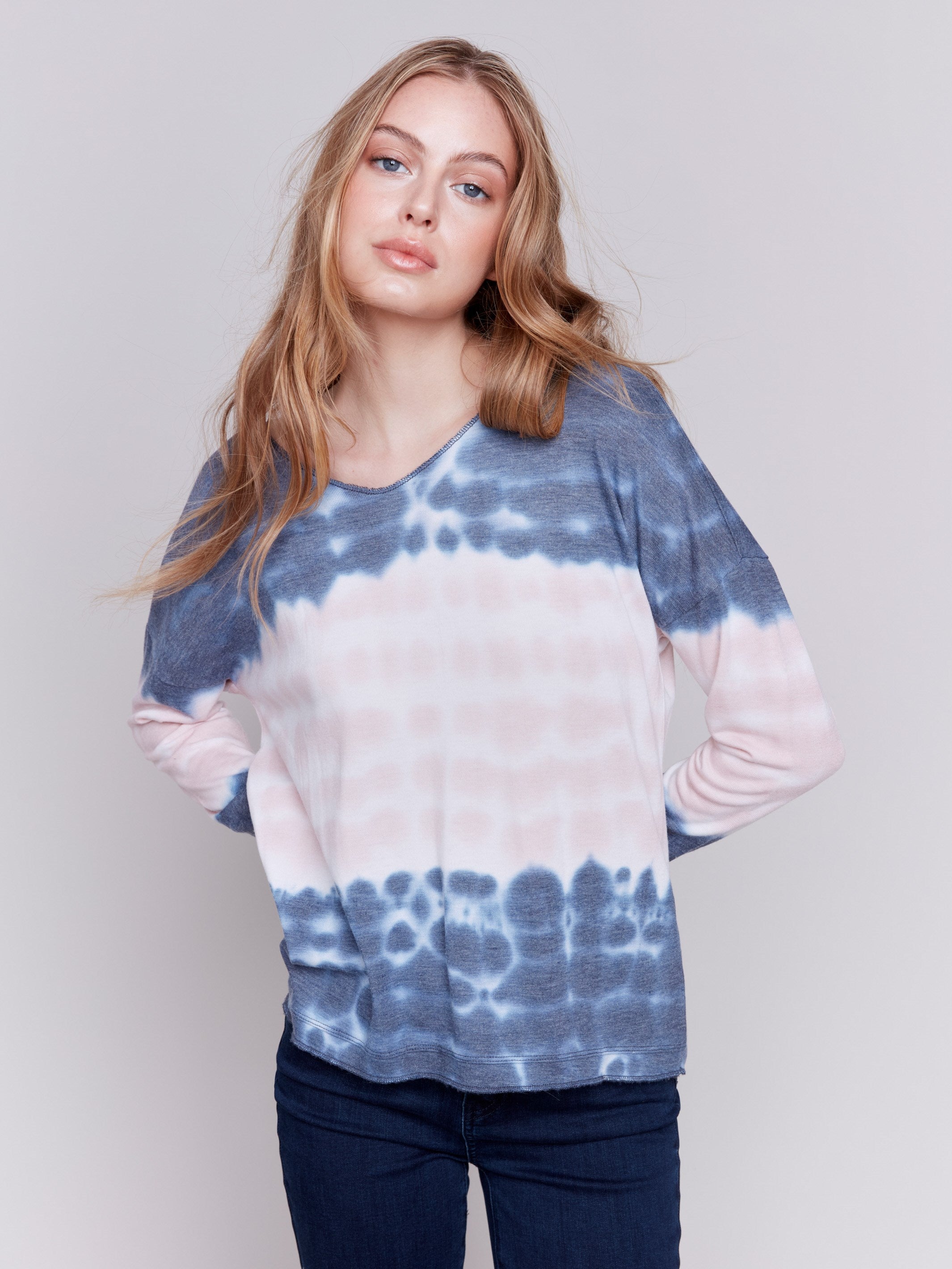 Long-sleeve V-neck knit top with a unique tie-dye wave pattern in blue by Charlie B.