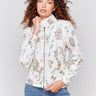 White faux leather jacket with floral print, stand collar, front zipper, and zipper pocket details by Charlie B.