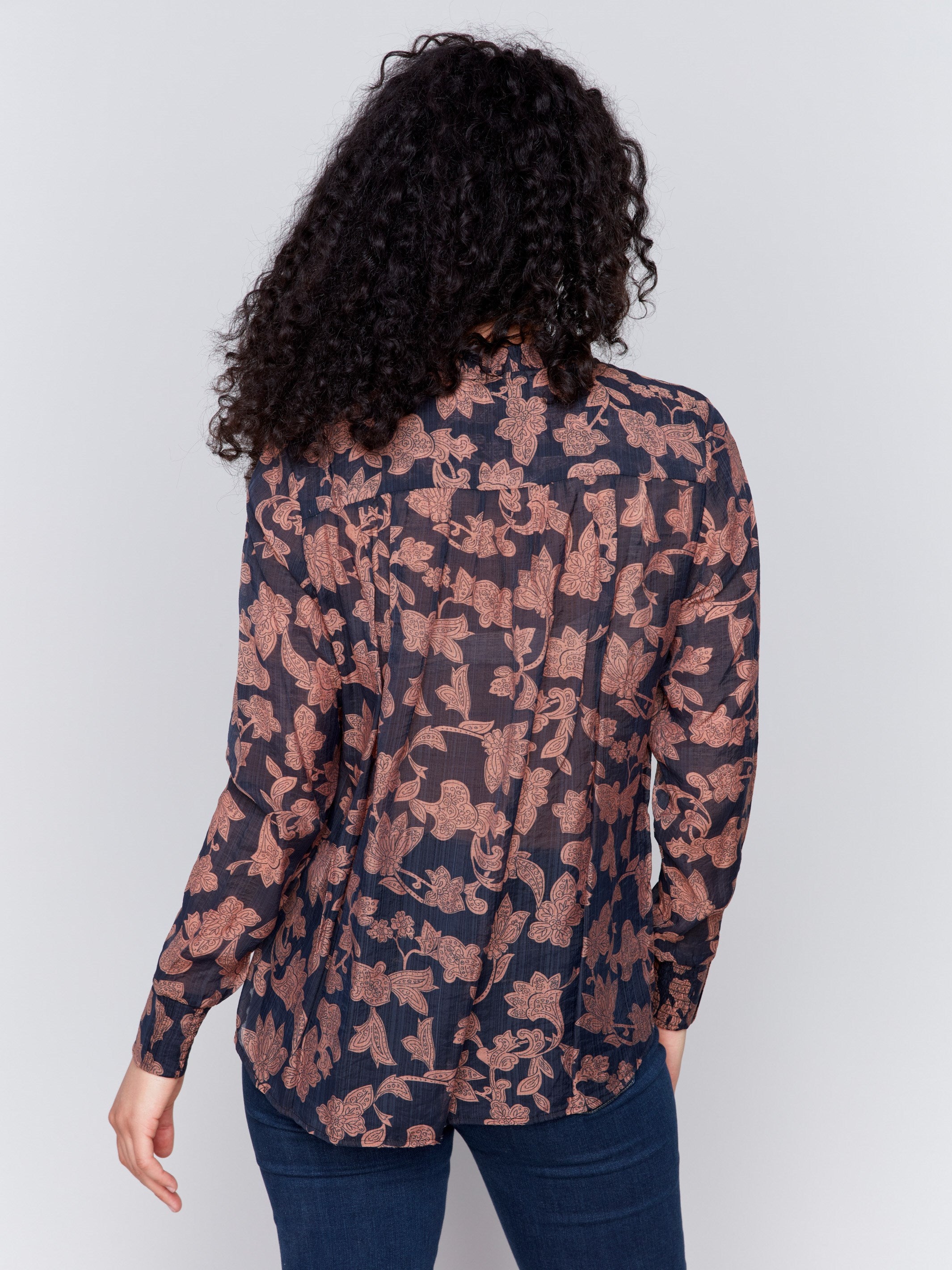 Elegant printed voile blouse with floral pattern, featuring a smocked collar and tie-up neckline by Charlie B.