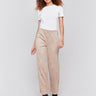 Natural beige faux suede flare pants with a pull-on style, featuring two back welt pockets by Charlie B.