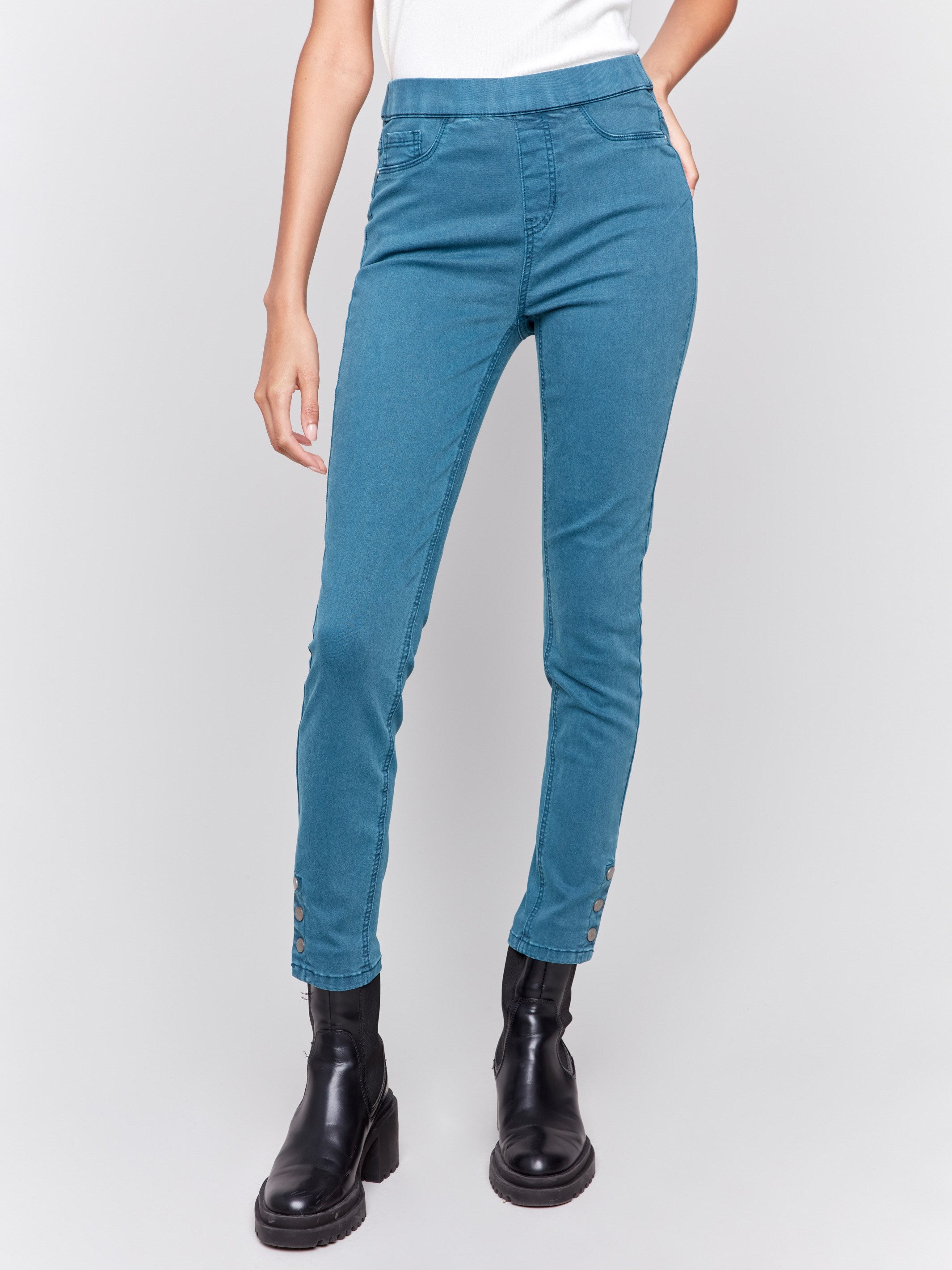 Pull-on twill pants in peacock blue with snap button hem, slim leg, and regular rise by Charlie B.