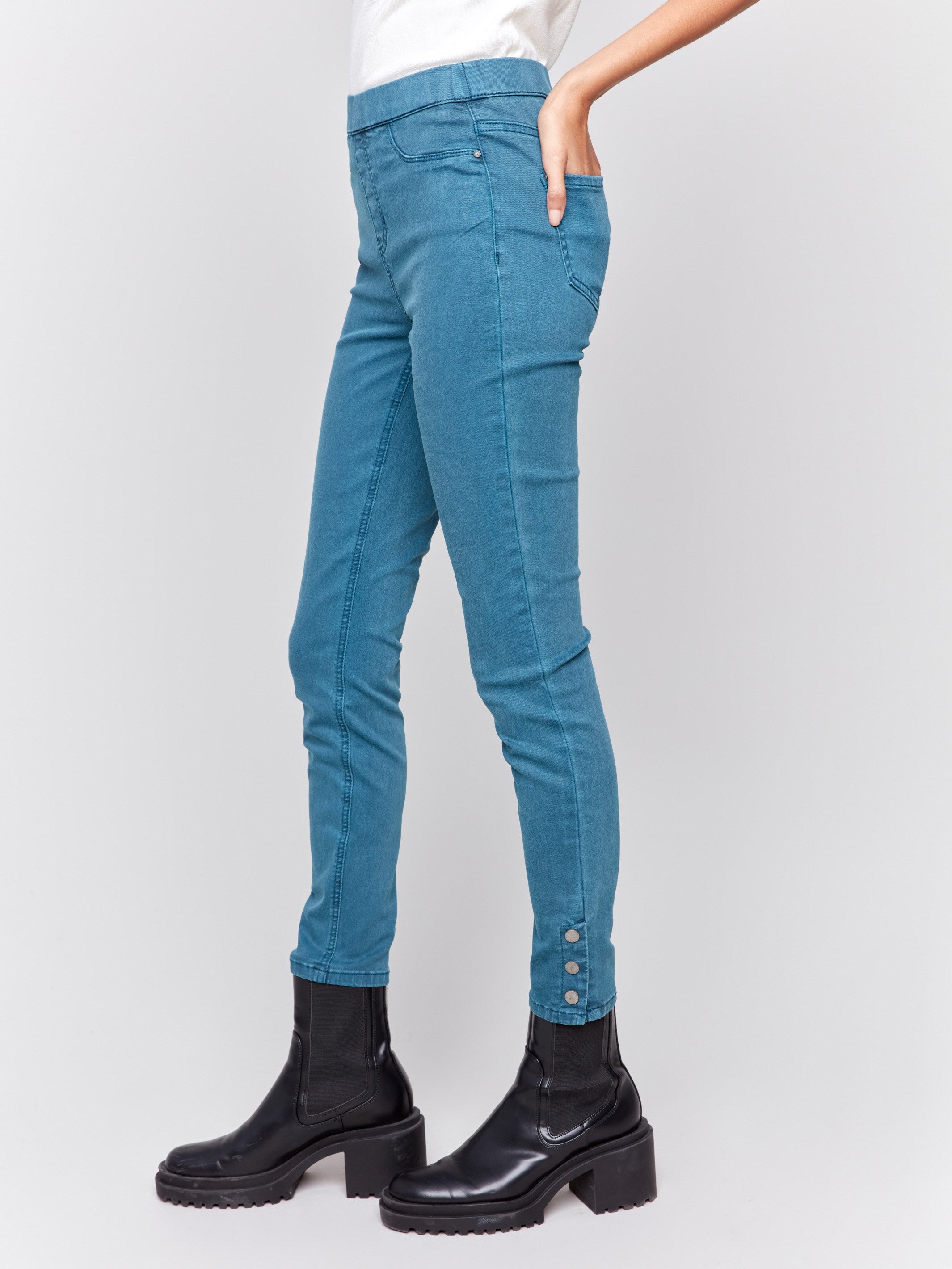 Pull-on twill pants in peacock blue with snap button hem, slim leg, and regular rise by Charlie B.