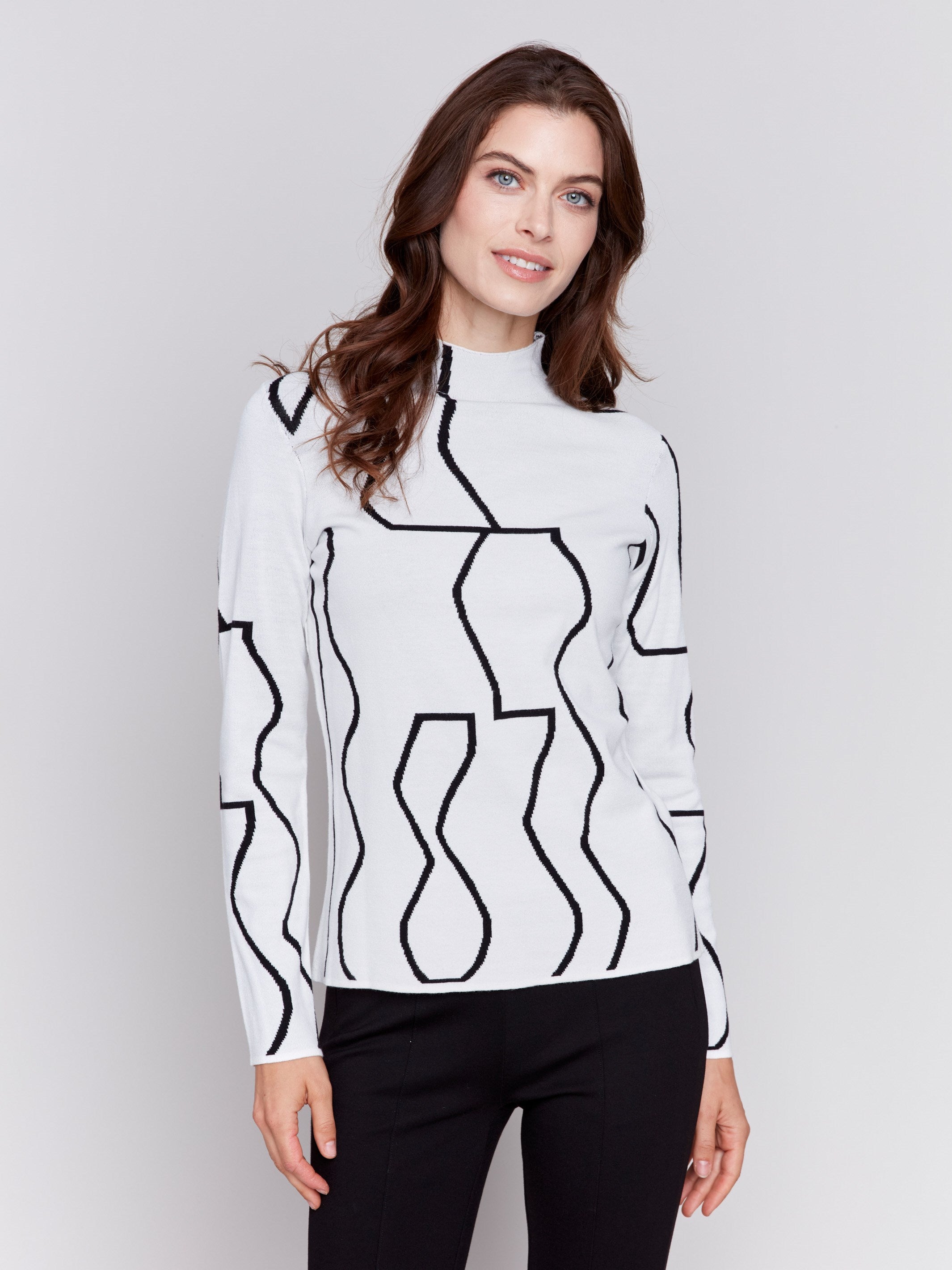 Black and cream reversible jacquard mock neck sweater with geometric patterns, featuring long sleeves by Charlie B.