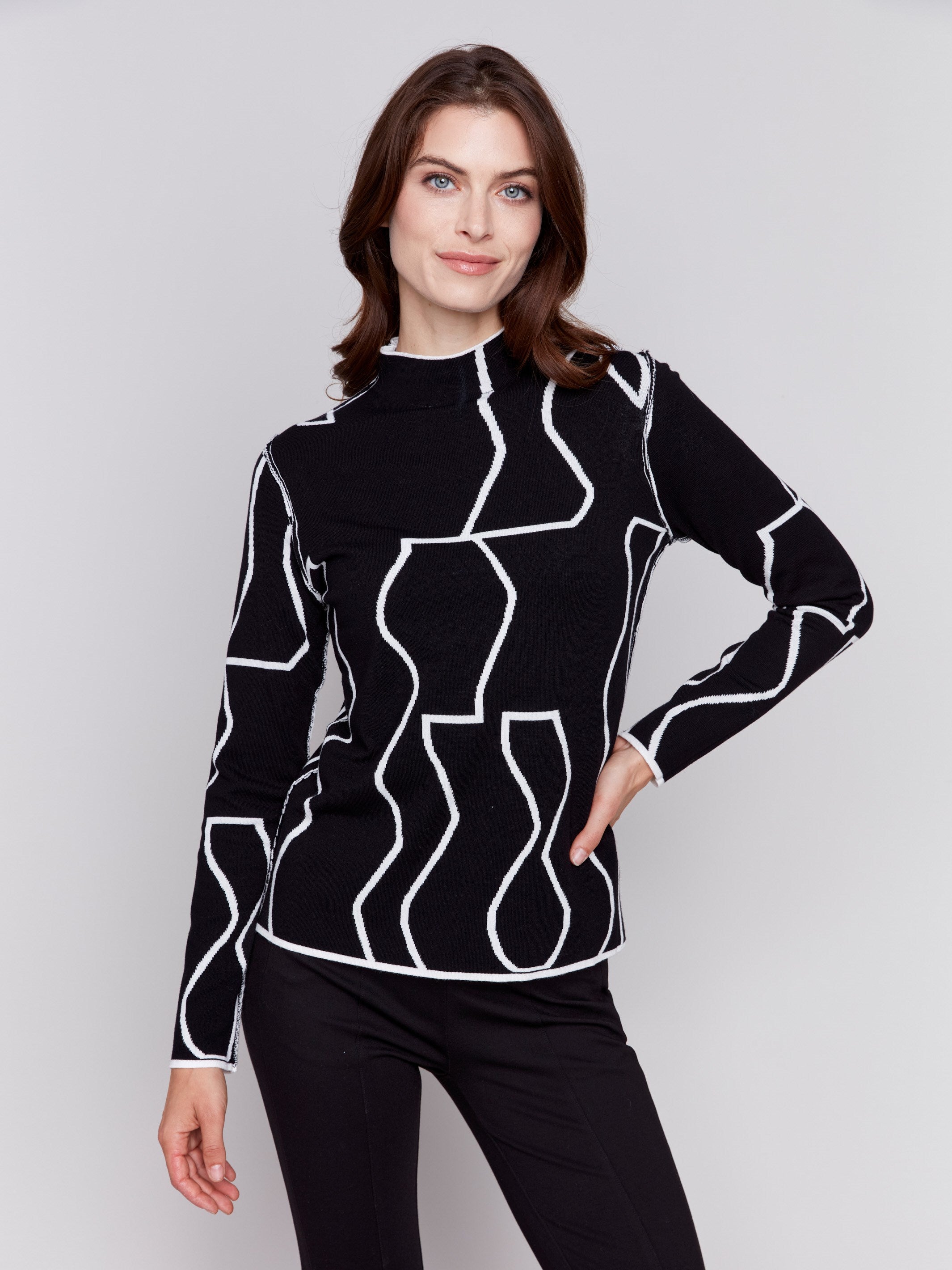 Black and cream reversible jacquard mock neck sweater with geometric patterns, featuring long sleeves by Charlie B.