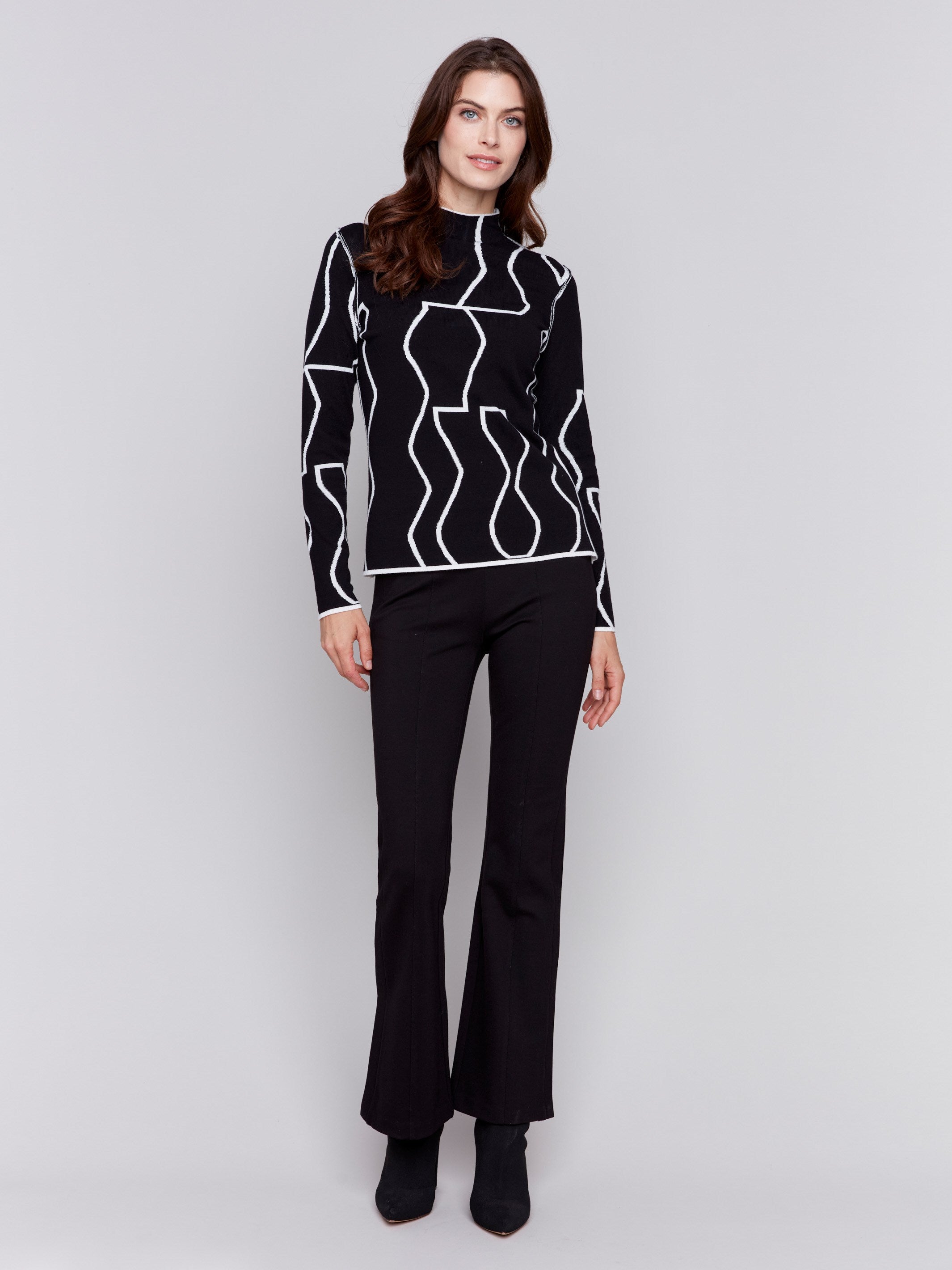 Black and cream reversible jacquard mock neck sweater with geometric patterns, featuring long sleeves by Charlie B.