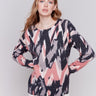 Woodrose reversible sweater with an abstract pattern, featuring raglan sleeves and a crew neckline by Charlie B.