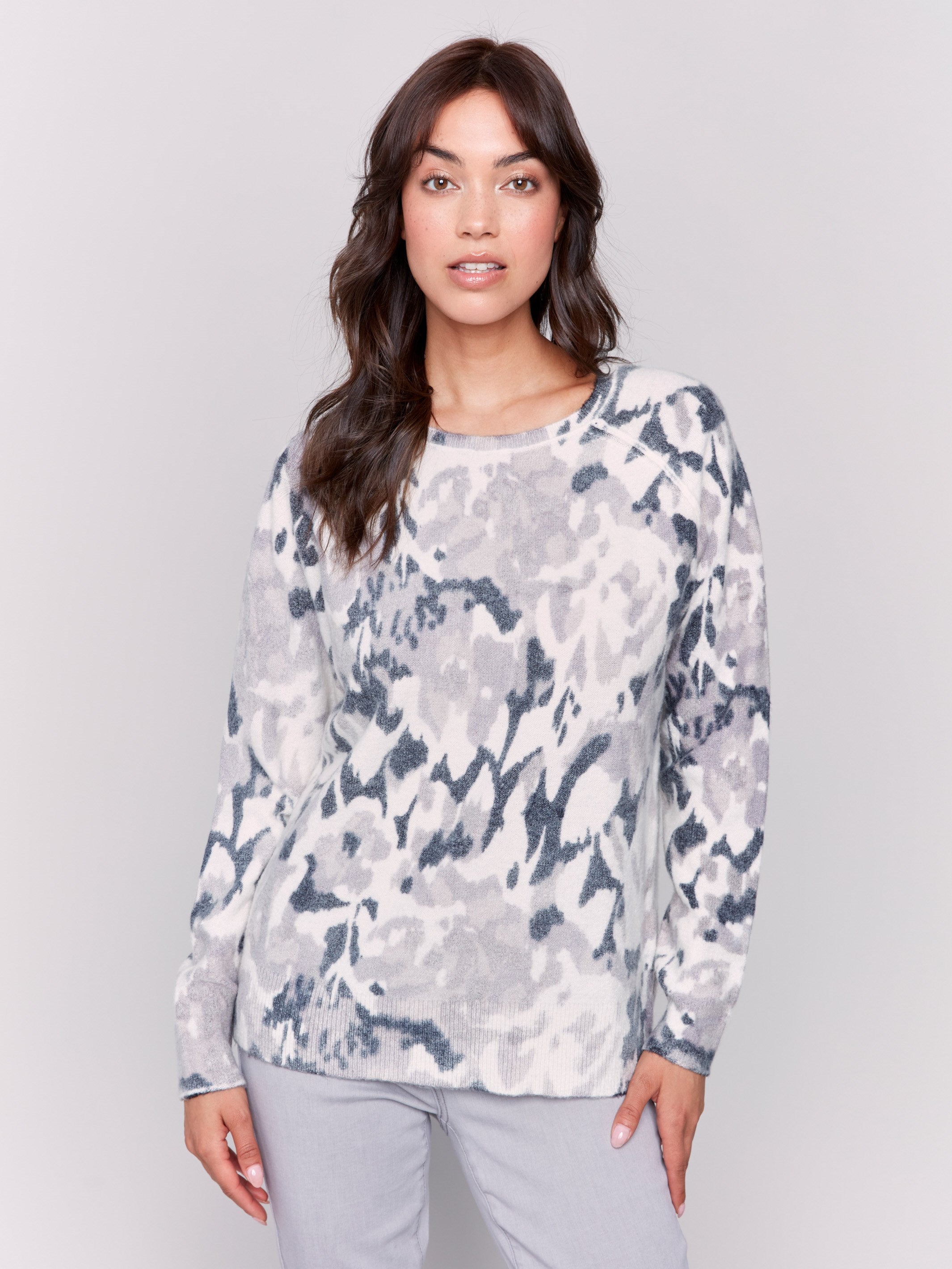 Black and grey reversible sweater with a abstract pattern, featuring raglan sleeves and a crew neckline by Charlie B.