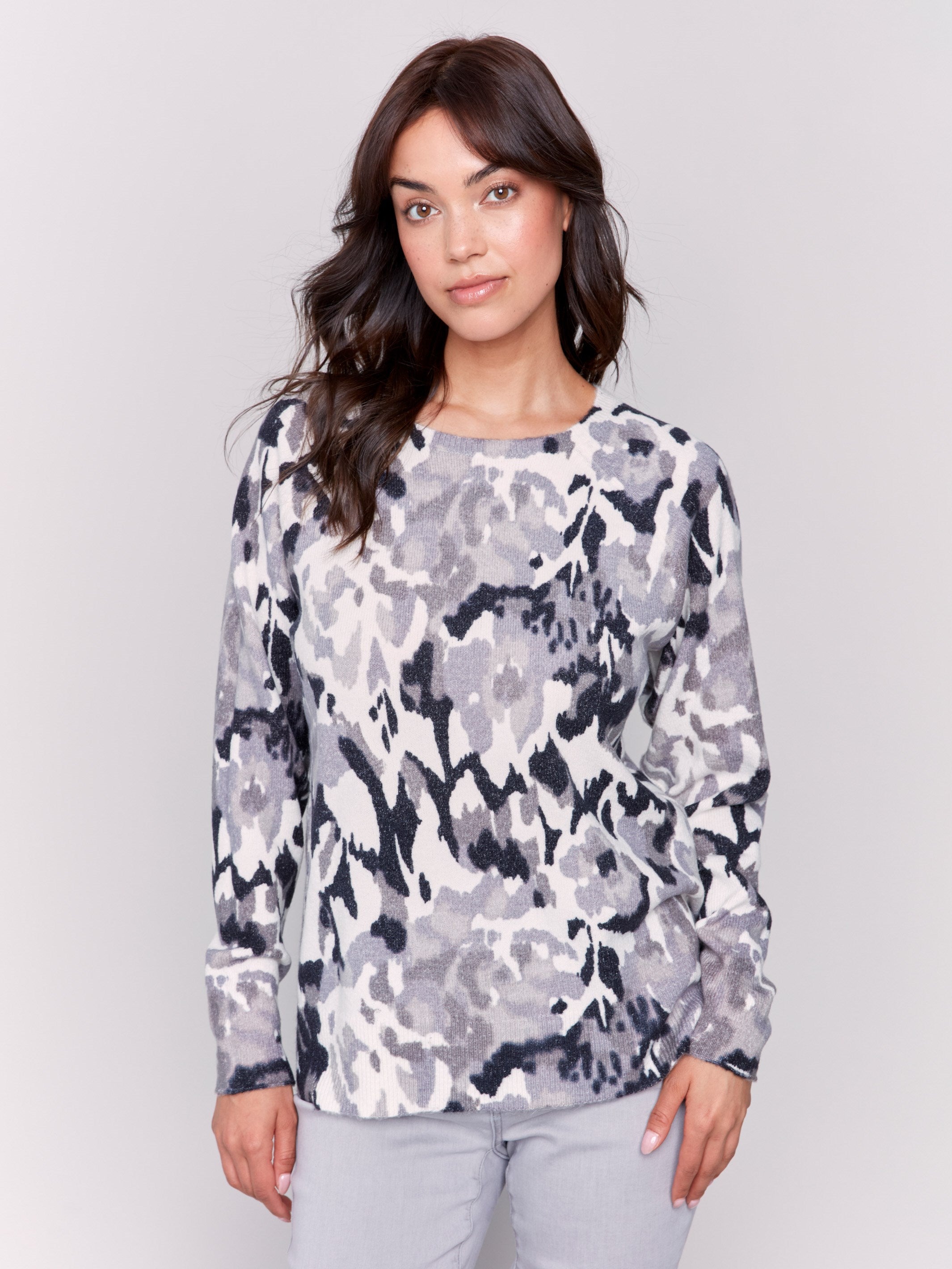 Black and grey reversible sweater with a abstract pattern, featuring raglan sleeves and a crew neckline by Charlie B.