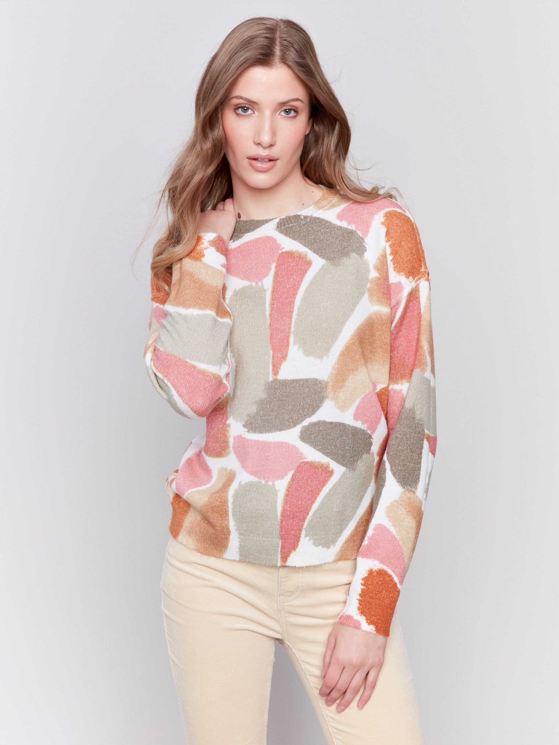 Women wearing reversible printed sweater with artistic prints and a crew neckline by Charlie B.