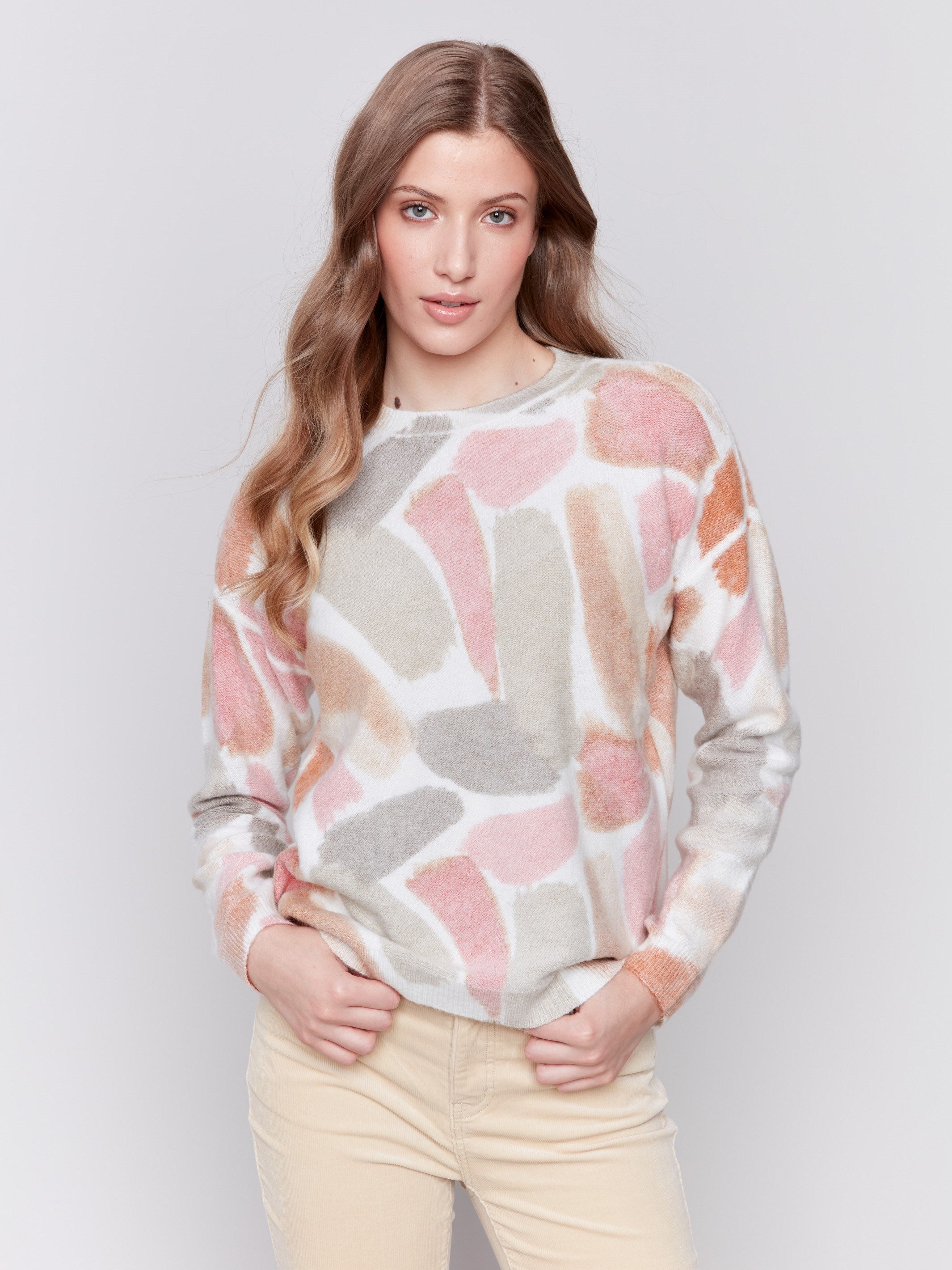 Women wearing reversible printed sweater with artistic prints and a crew neckline by Charlie B.