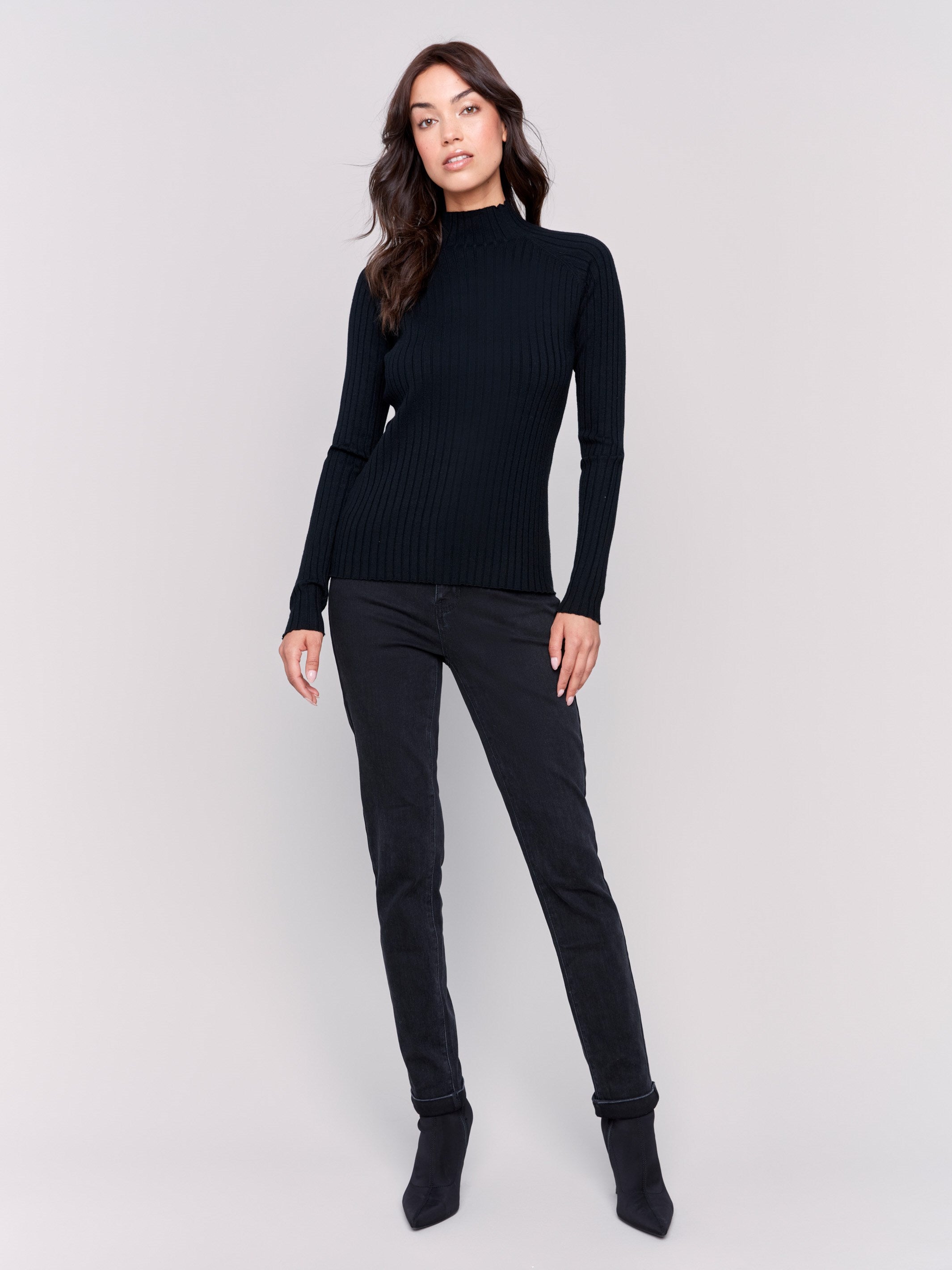 Black ribbed knit sweater with a mock neck and long sleeves by Charlie B.