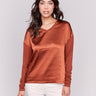 Terracotta satin and jersey top featuring V-neck design and long sleeves by Charlie B.