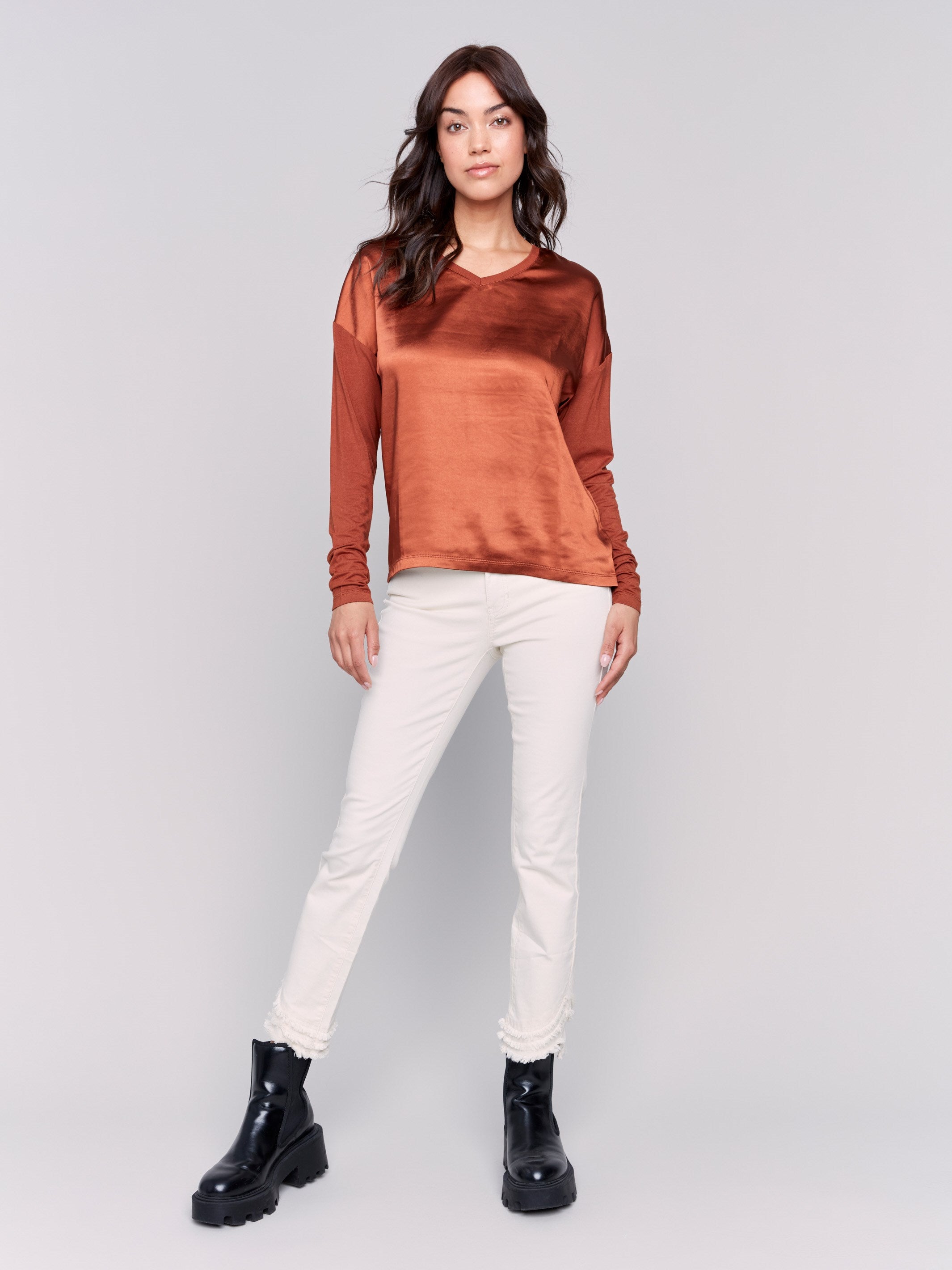 Terracotta satin and jersey top featuring V-neck design and long sleeves by Charlie B.