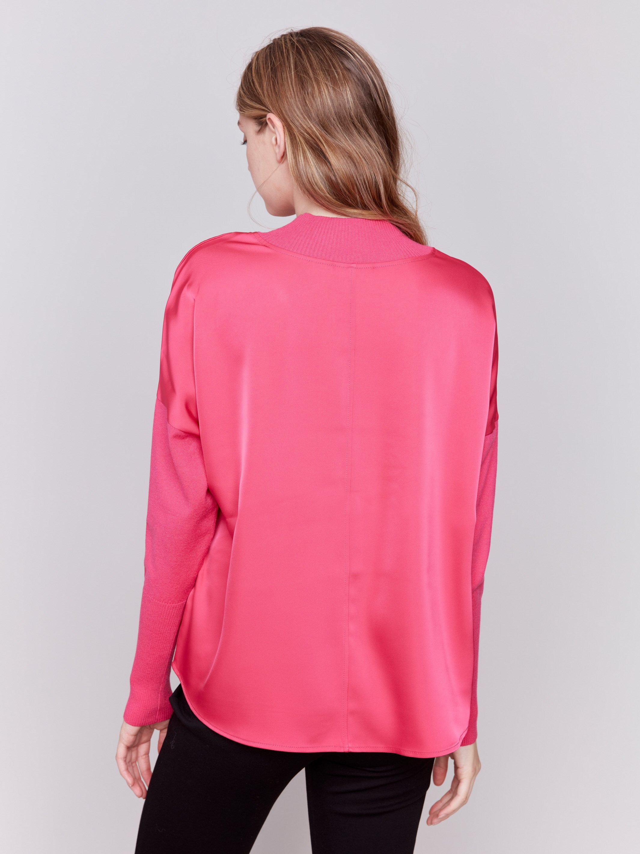 Magenta pink satin-knit top with a mock neck and front seam detail, featuring long sleeves and ribbed cuffs by Charlie B.