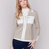 Beige short knit jacket with zipper closure and patch front pockets featuring stylish design by Charlie B.