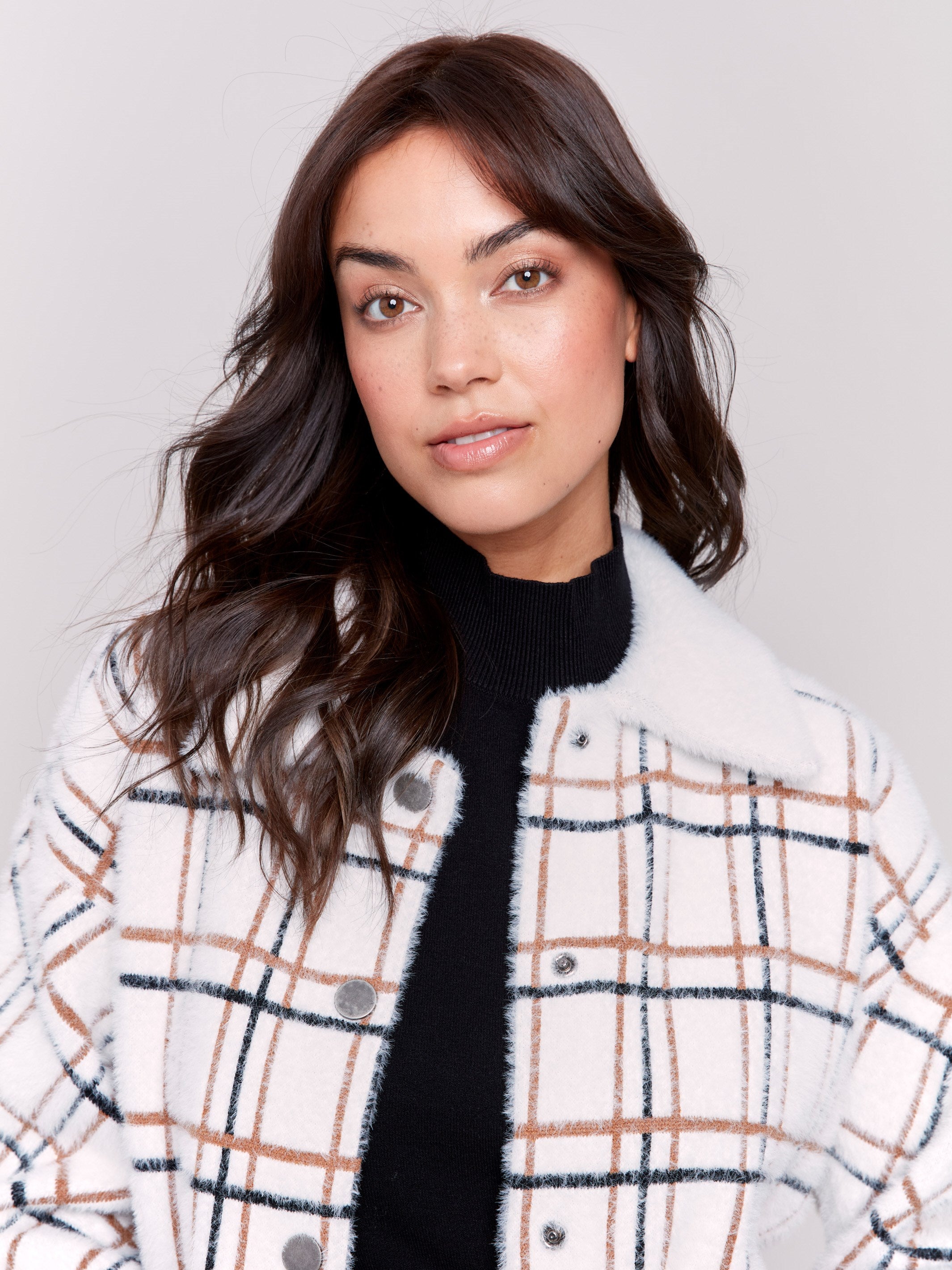 Short plaid knit jacket with a classic design in terracotta tones, featuring patch pockets and full button closure by Charlie B.