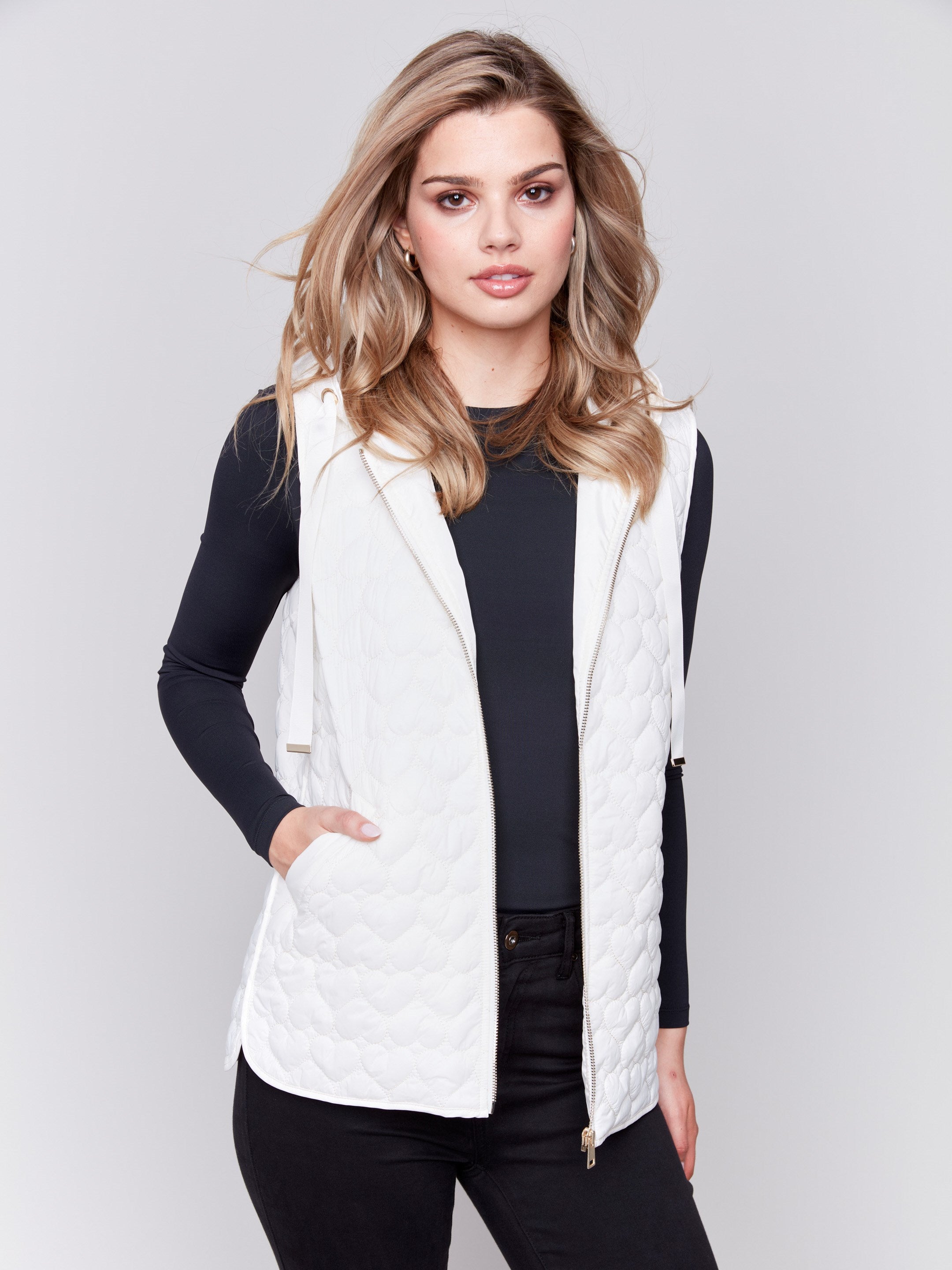 Ecru white short quilted puffer vest with a hood, featuring a mini heart pattern and front pockets by Charlie B.