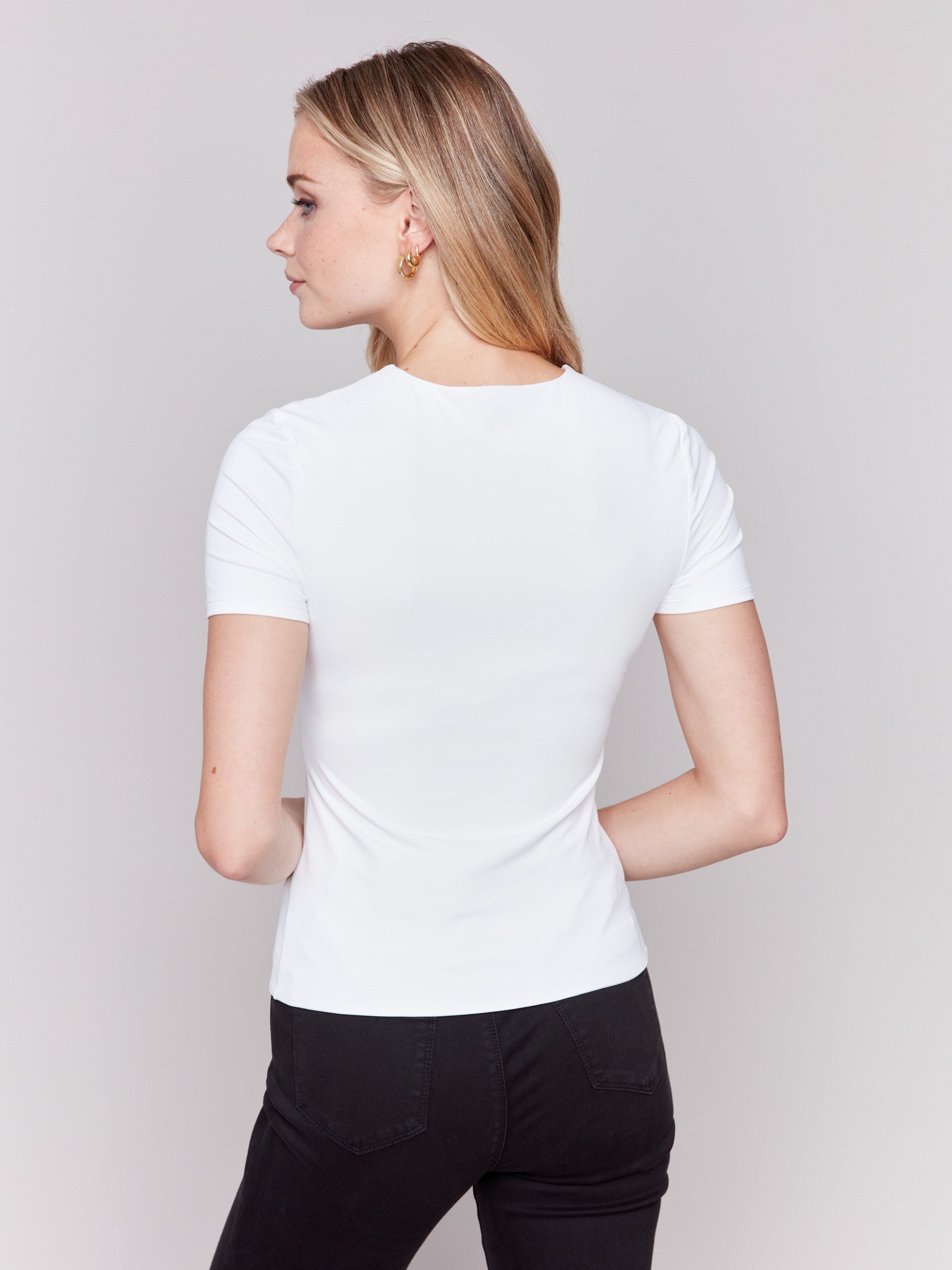 White short-sleeved super stretch top with a crew neckline, showcasing a slim fit design by Charlie B.