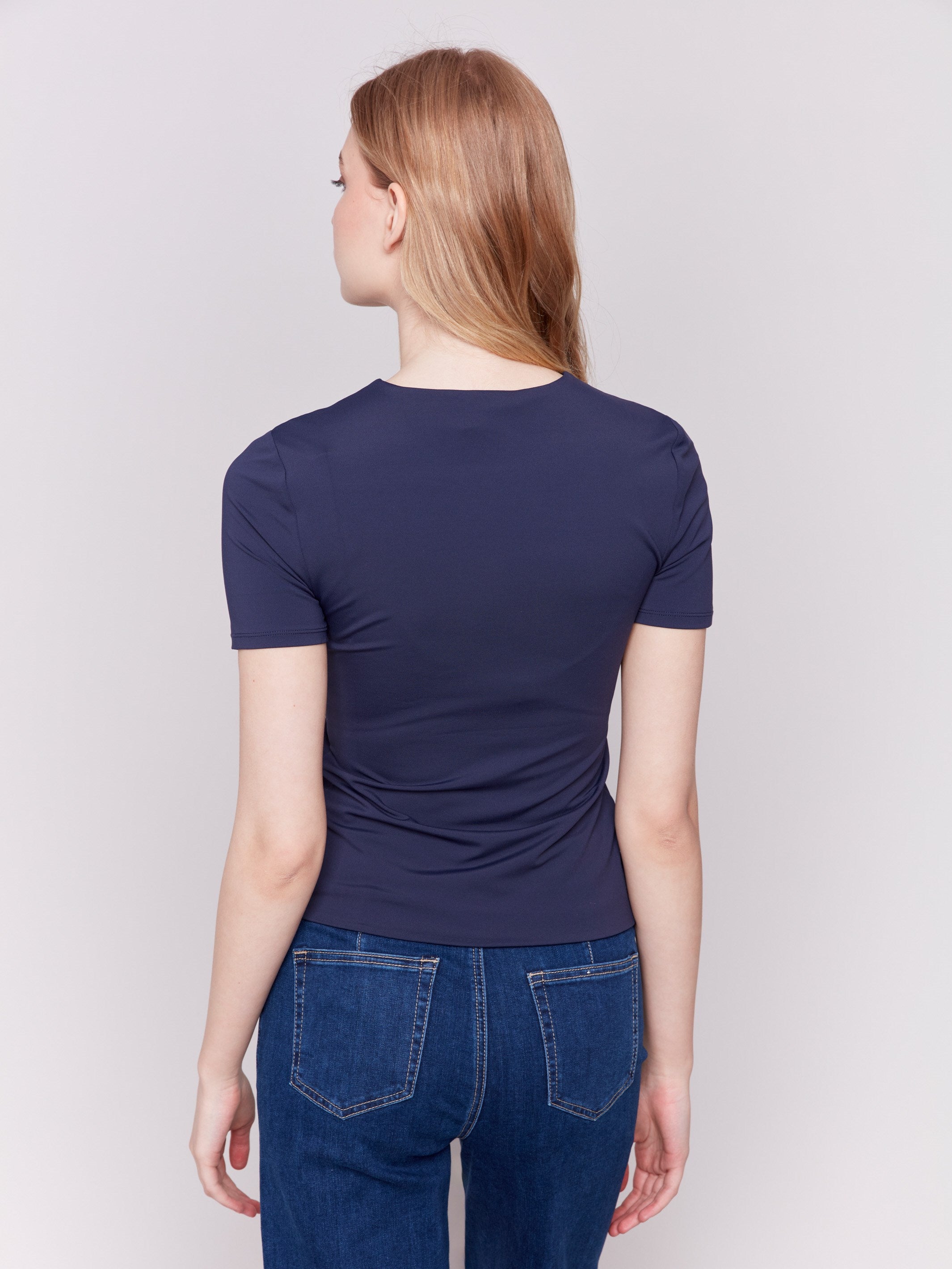 Navy short-sleeved super stretch top with a crew neckline, showcasing a slim fit design by Charlie B.