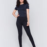 Black skinny twill pants with a mid-rise waist, skinny fit, and front zipper pocket detail by Charlie B.