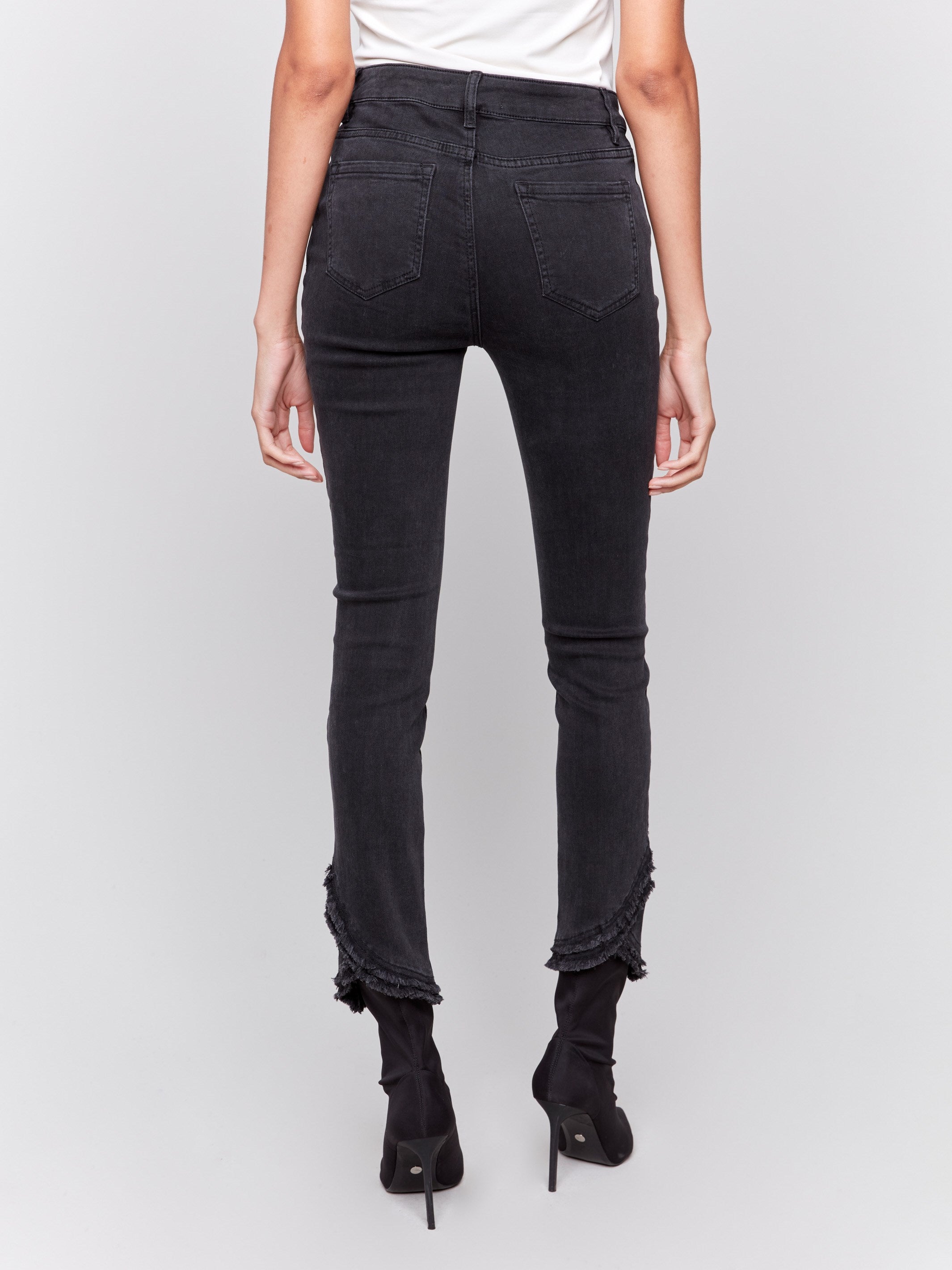 Charcoal slim fit jeans with frayed tulip hem, featuring a five-pocket design and button closure by Charlie B.