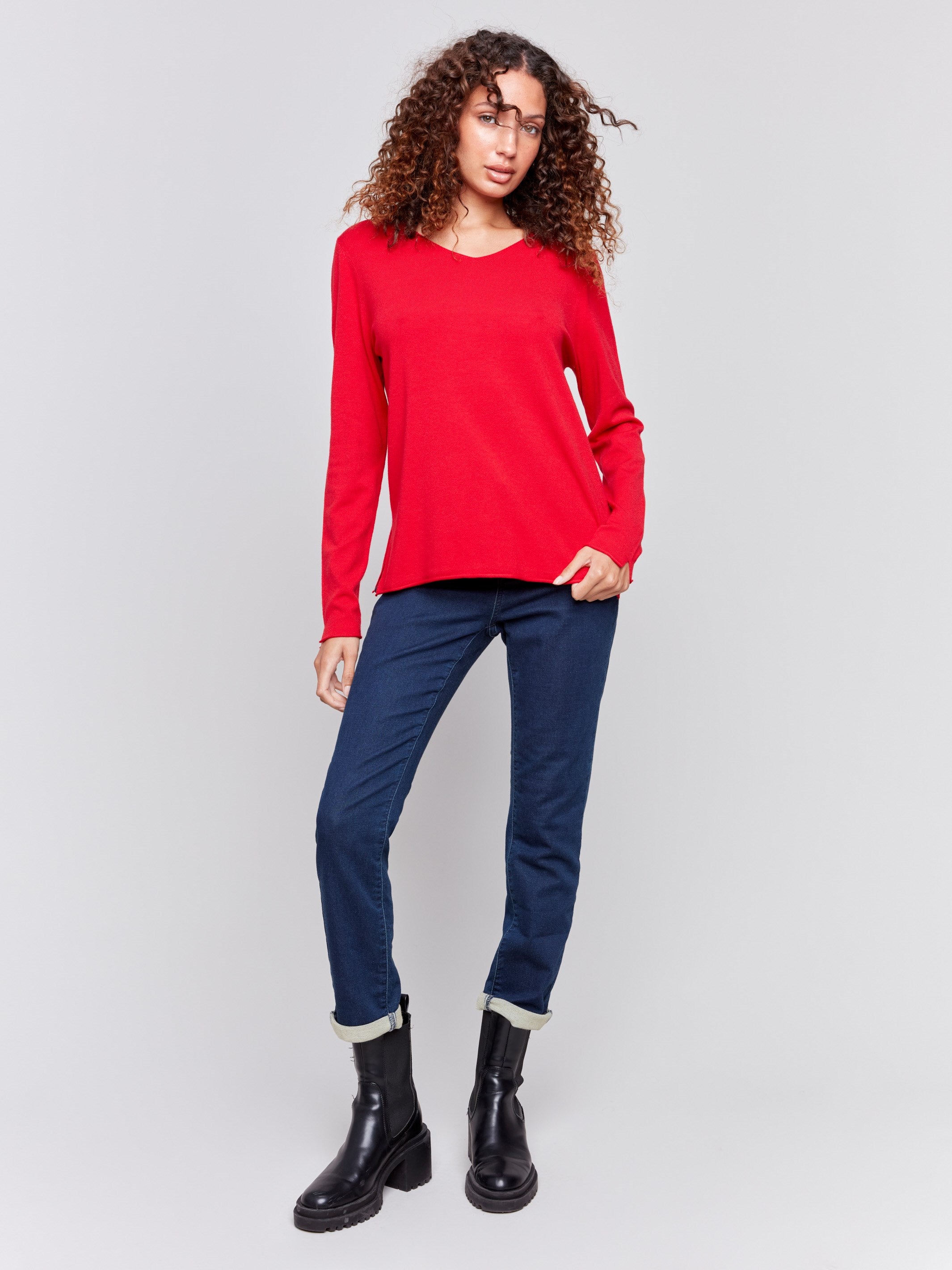 Cranberry red V-neck sweater with long sleeves featuring side slits, made from plushy yarn by Charlie B.