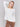 Ecru white V-neck sweater with long sleeves featuring side slits, made from plushy yarn by Charlie B.