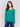 Forest green V-neck sweater with long sleeves featuring side slits, made from plushy yarn by Charlie B.