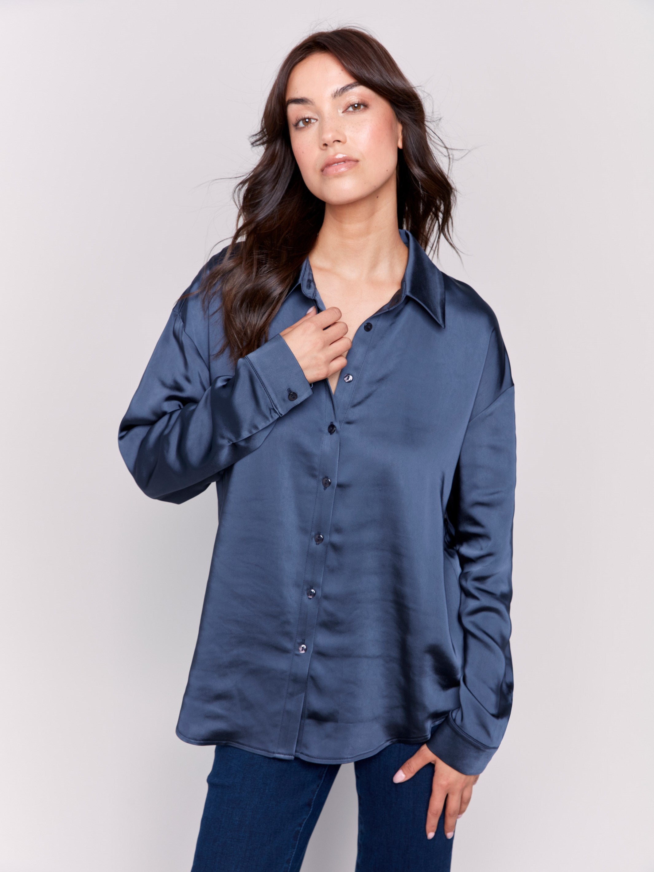 Navy blue solid satin button-down shirt with long sleeves, shirt collar, and a smooth finish by Charlie B.