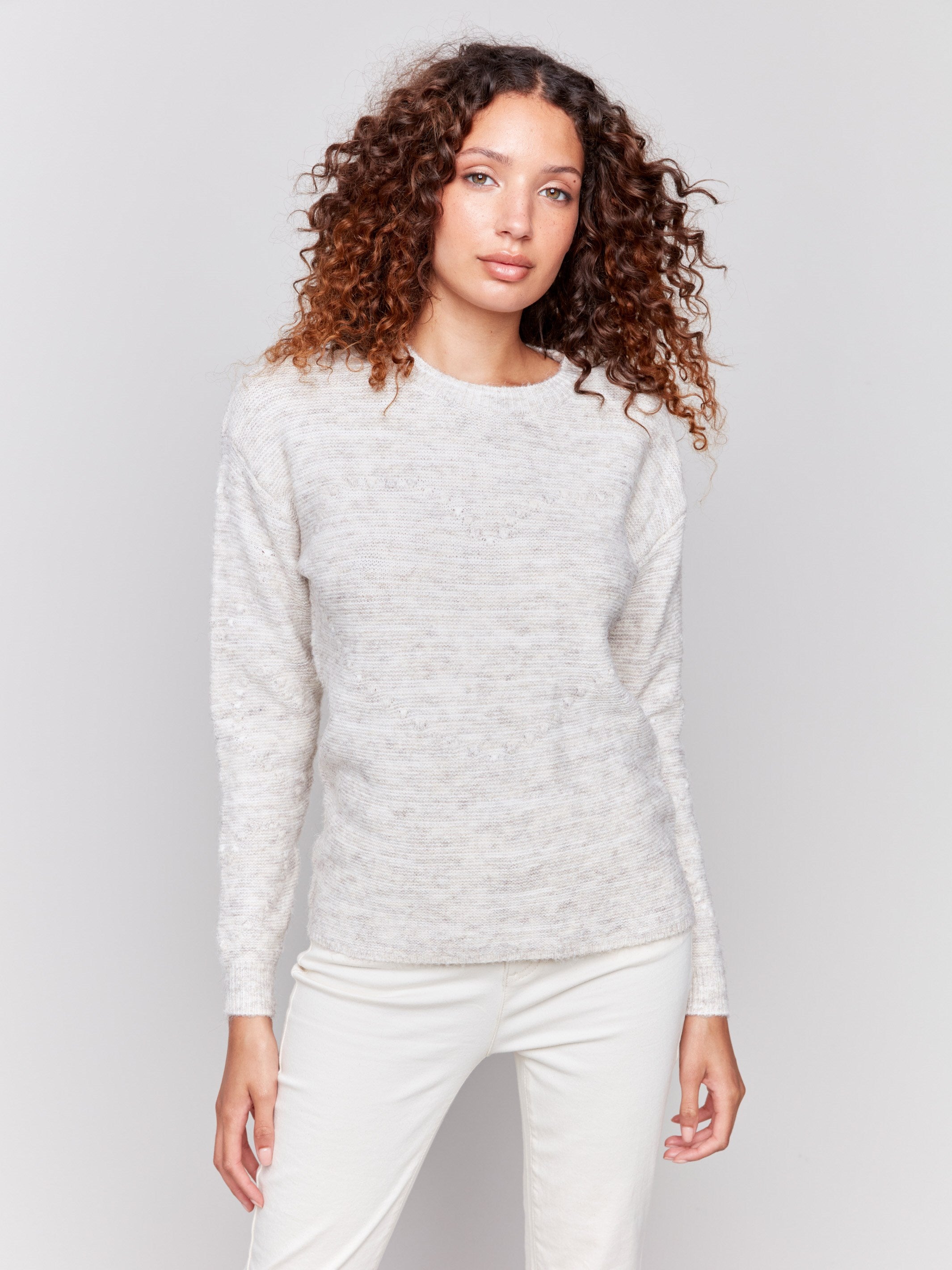 Ecru space dye knit sweater with drop shoulders and a crew neckline by Charlie B.