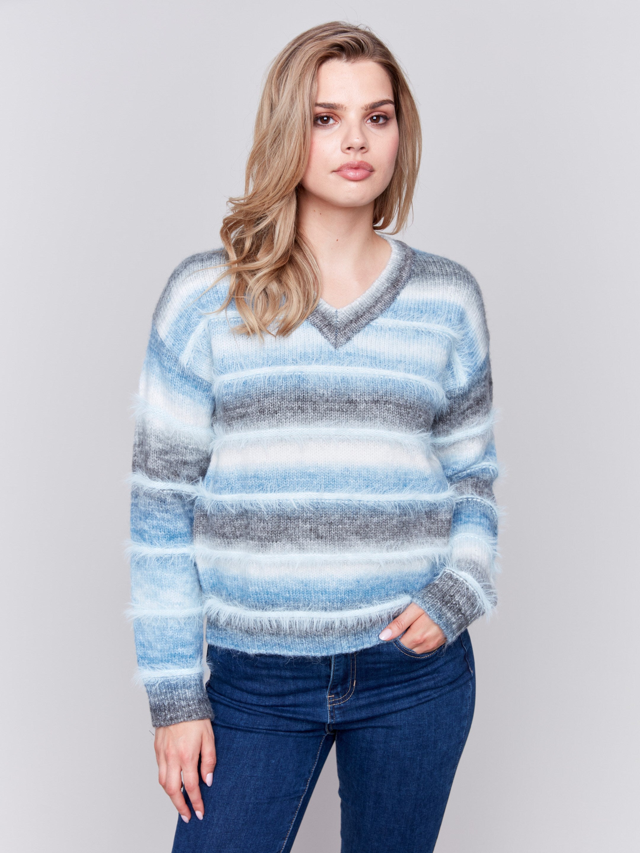 Frost-colored sweater with a subtle V-neck and a striped pattern made of eyelash yarn by Charlie B.