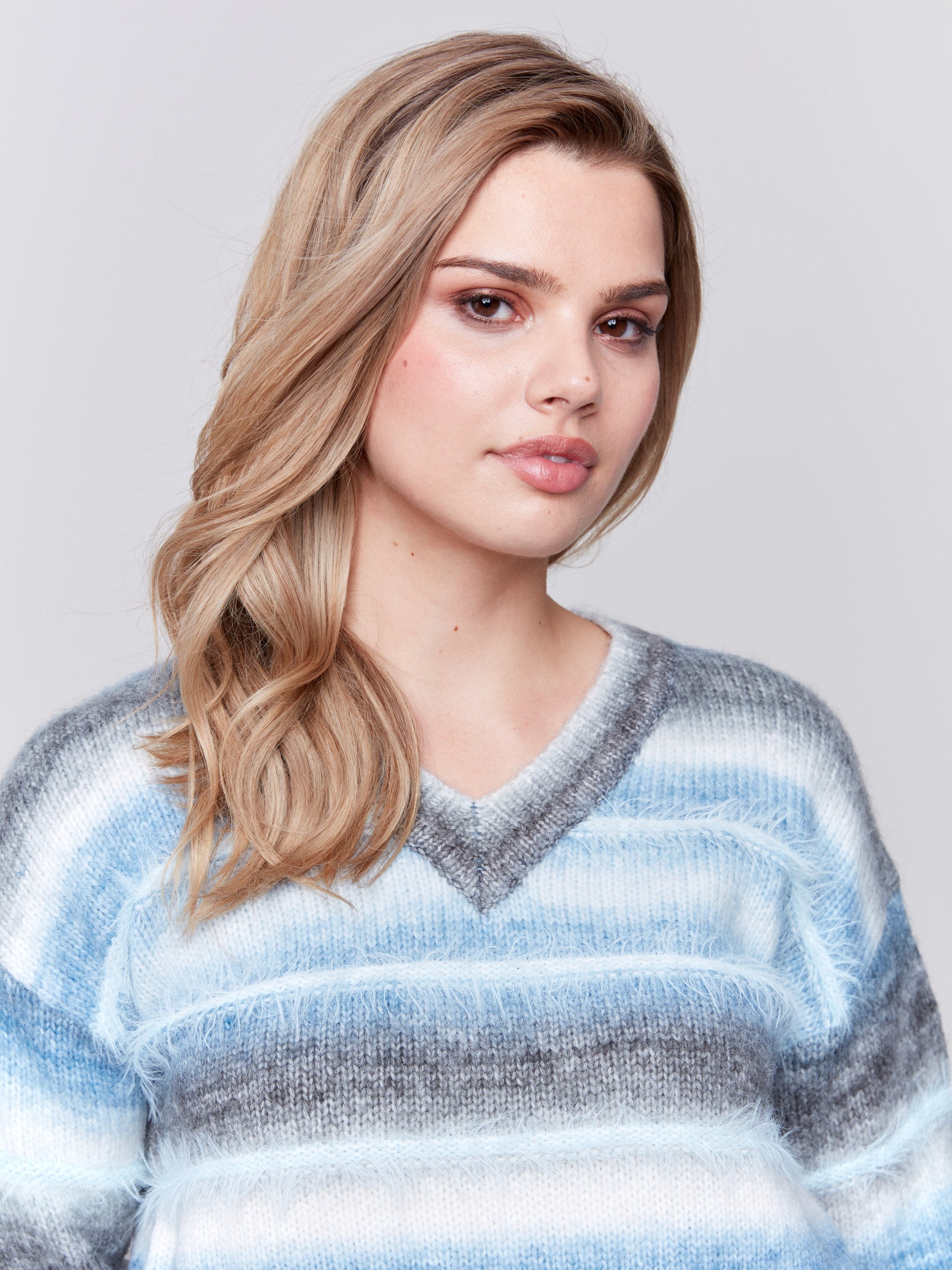 Frost-colored sweater with a subtle V-neck and a striped pattern made of eyelash yarn by Charlie B.