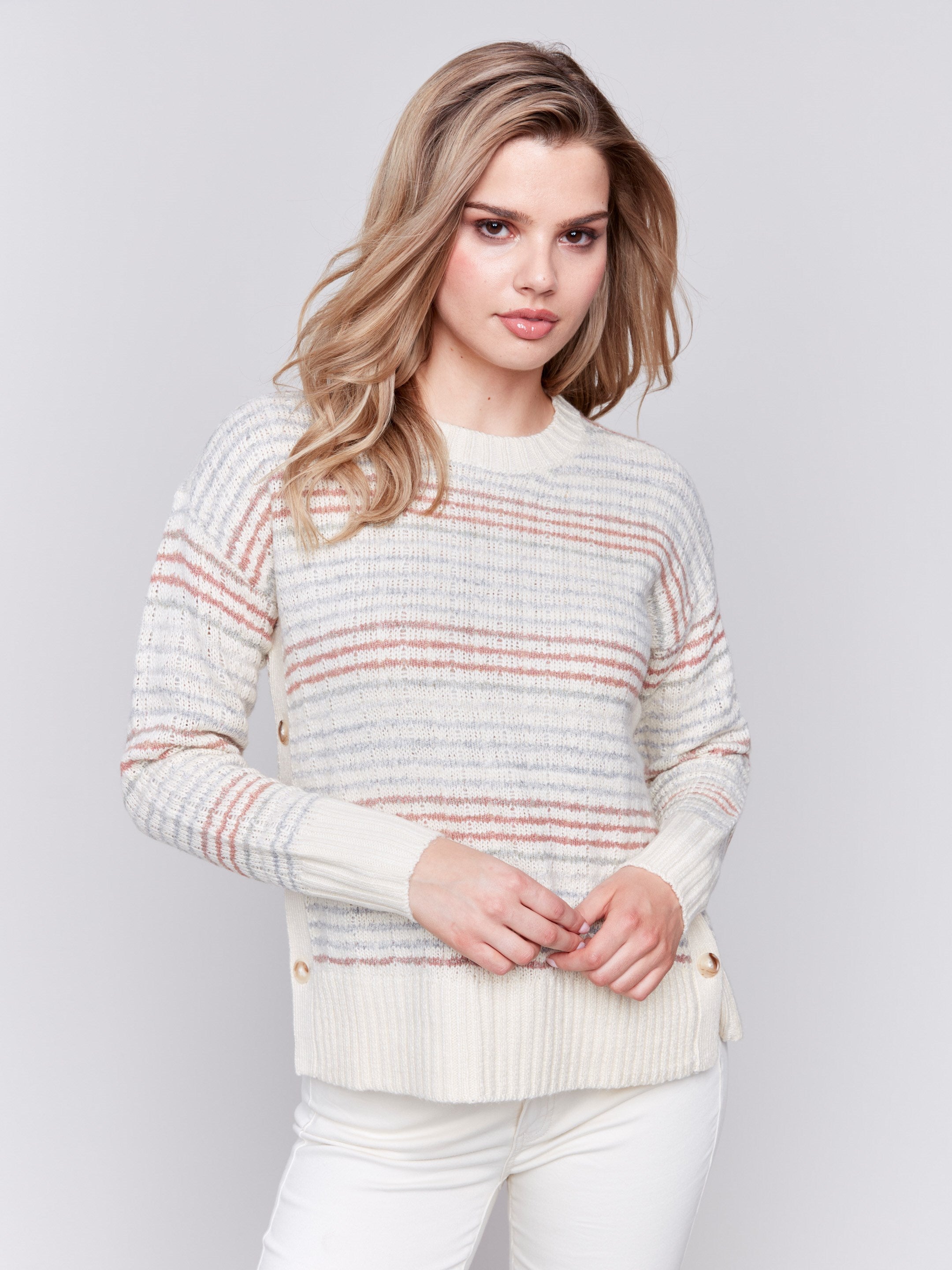 Ecru crew neck striped sweater with pastel stripes and side button detailing by Charlie B.