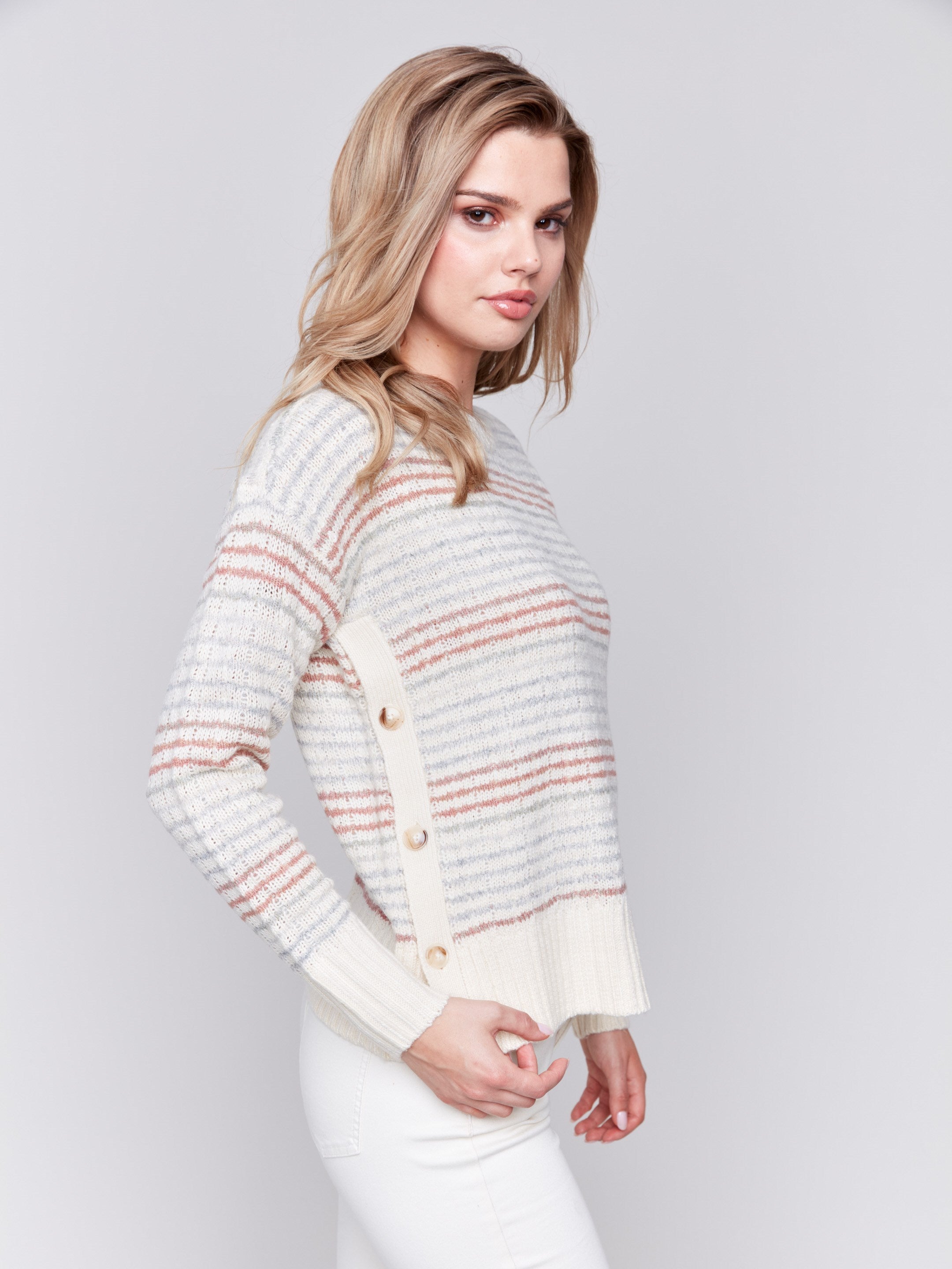 Ecru crew neck striped sweater with pastel stripes and side button detailing by Charlie B.