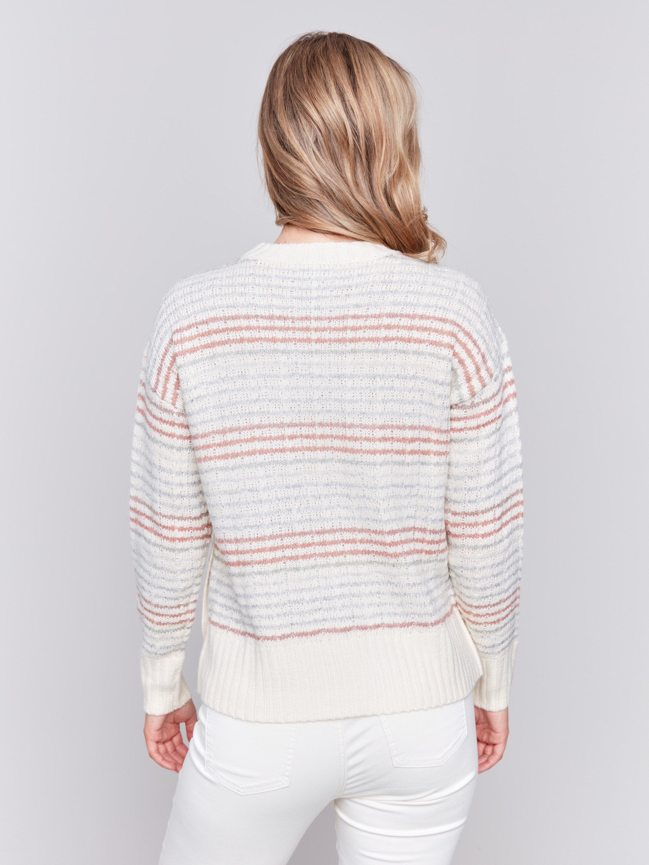 Ecru crew neck striped sweater with pastel stripes and side button detailing by Charlie B.