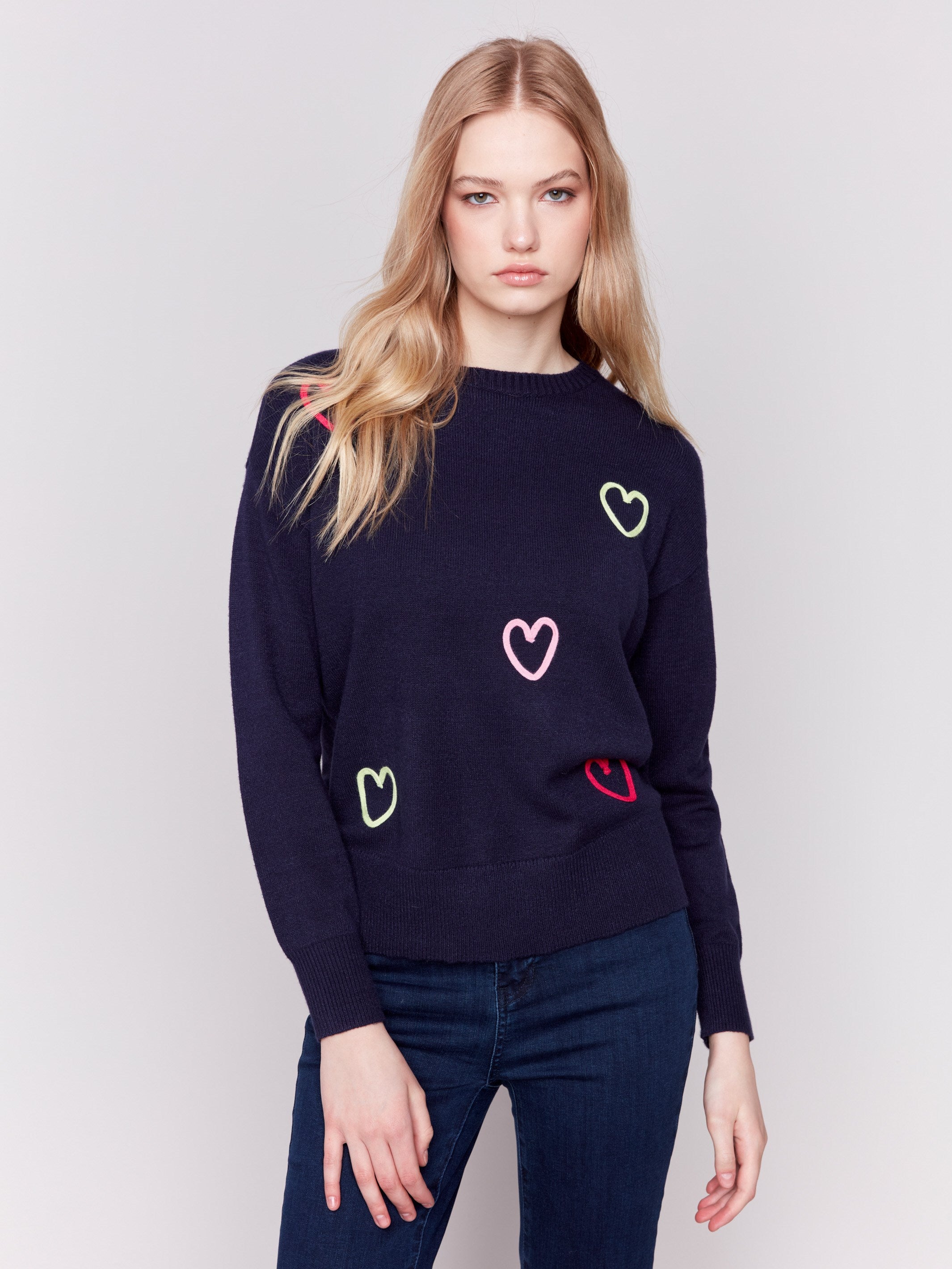 Navy blue sweater adorned with mini heart embroidery, featuring a crew neck and long sleeves by Charlie B.