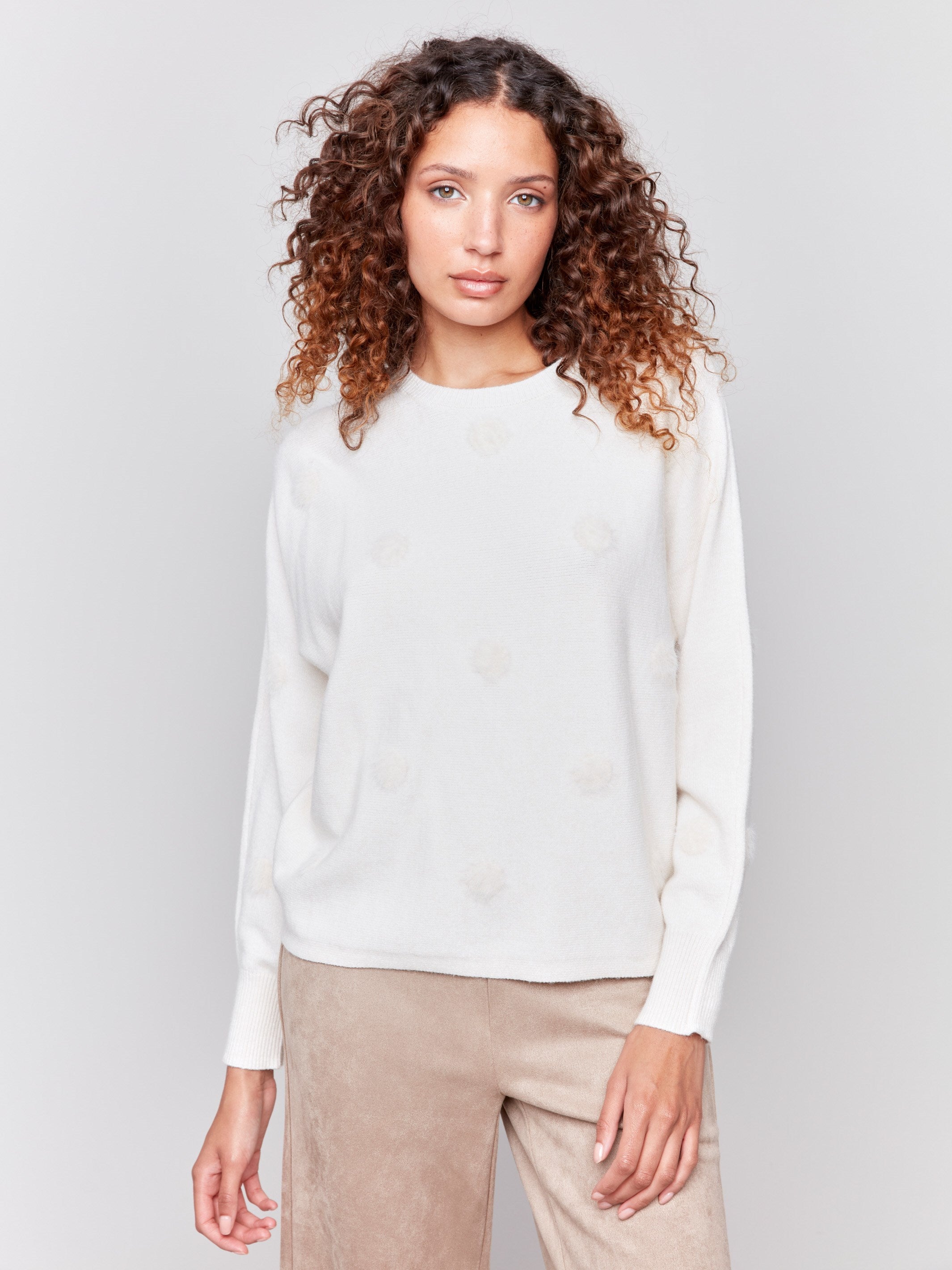 Off-white long-sleeve sweater with faux fur polka dots and a crew neckline by Charlie B.