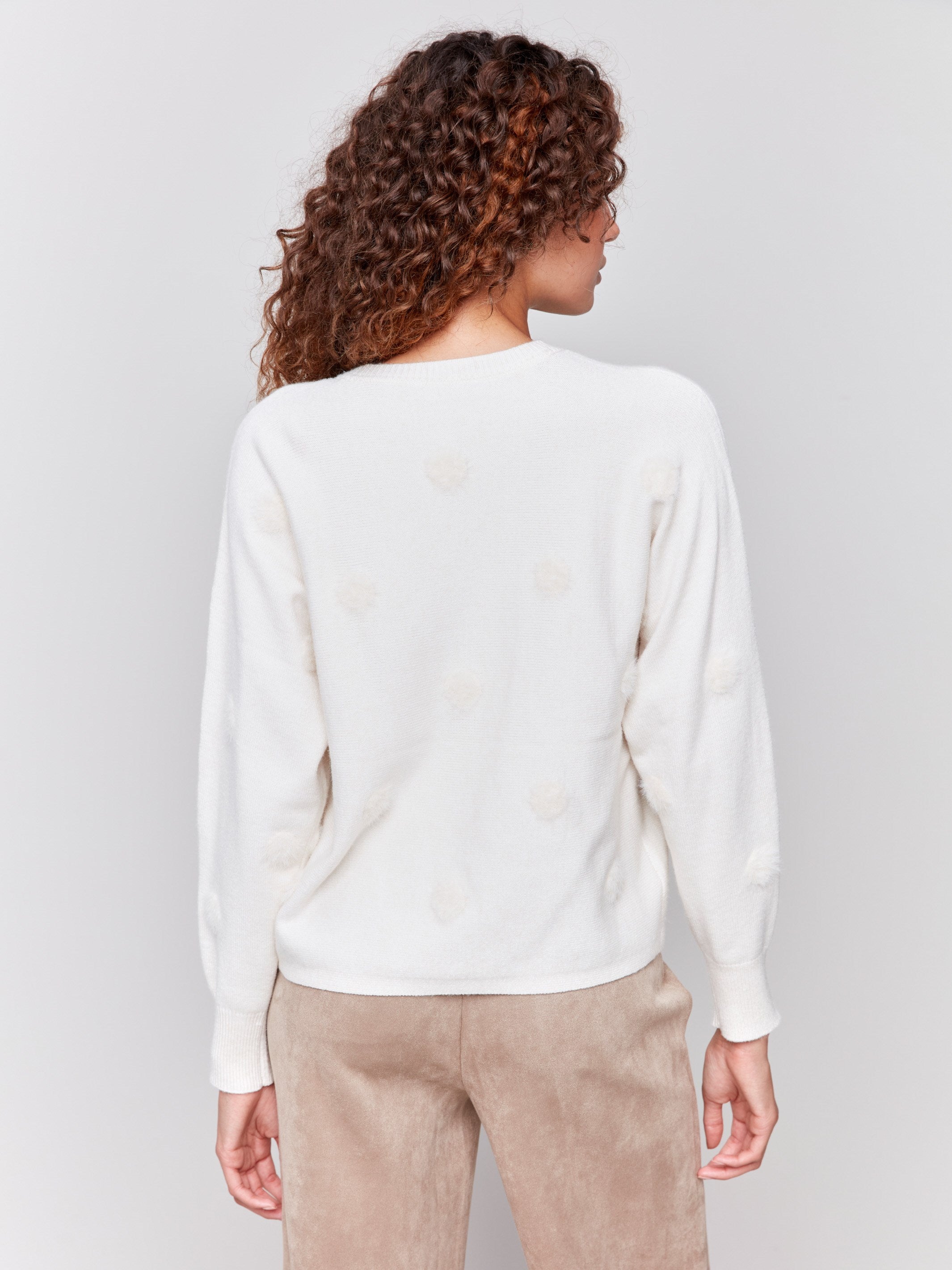 Off-white long-sleeve sweater with faux fur polka dots and a crew neckline by Charlie B.