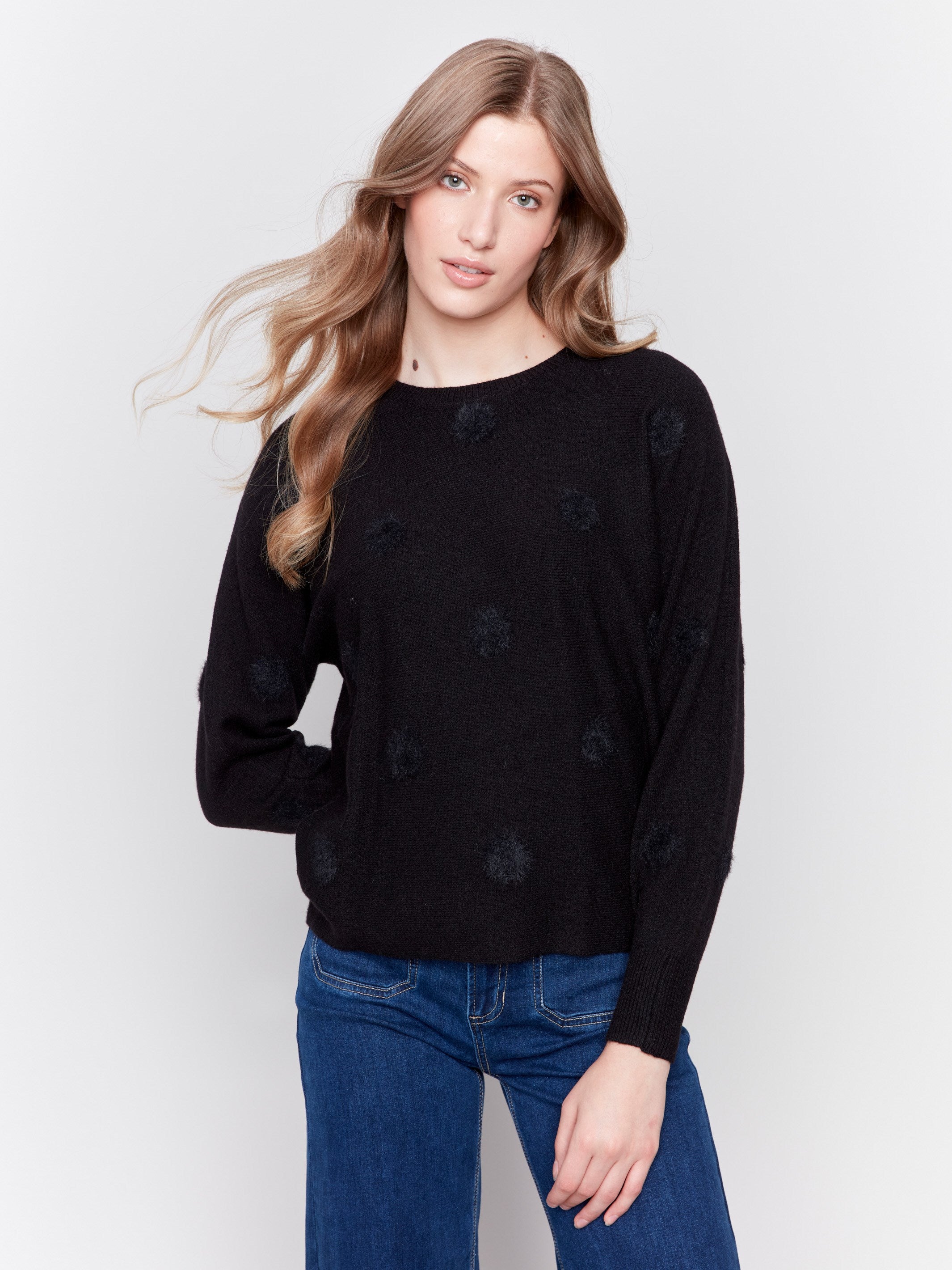 Black long-sleeve sweater with faux fur polka dots and a crew neckline by Charlie B.