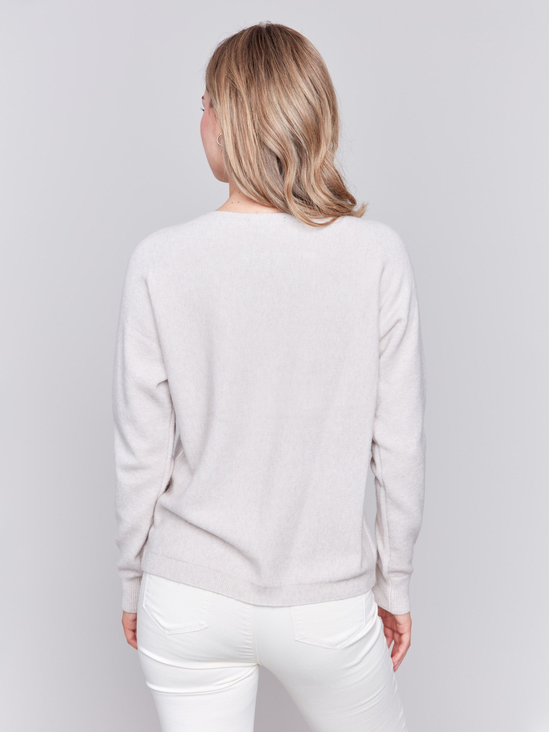 Heather almond long-sleeve sweater with fringed embroidery, featuring a round neckline and ribbed cuffs by Charlie B.