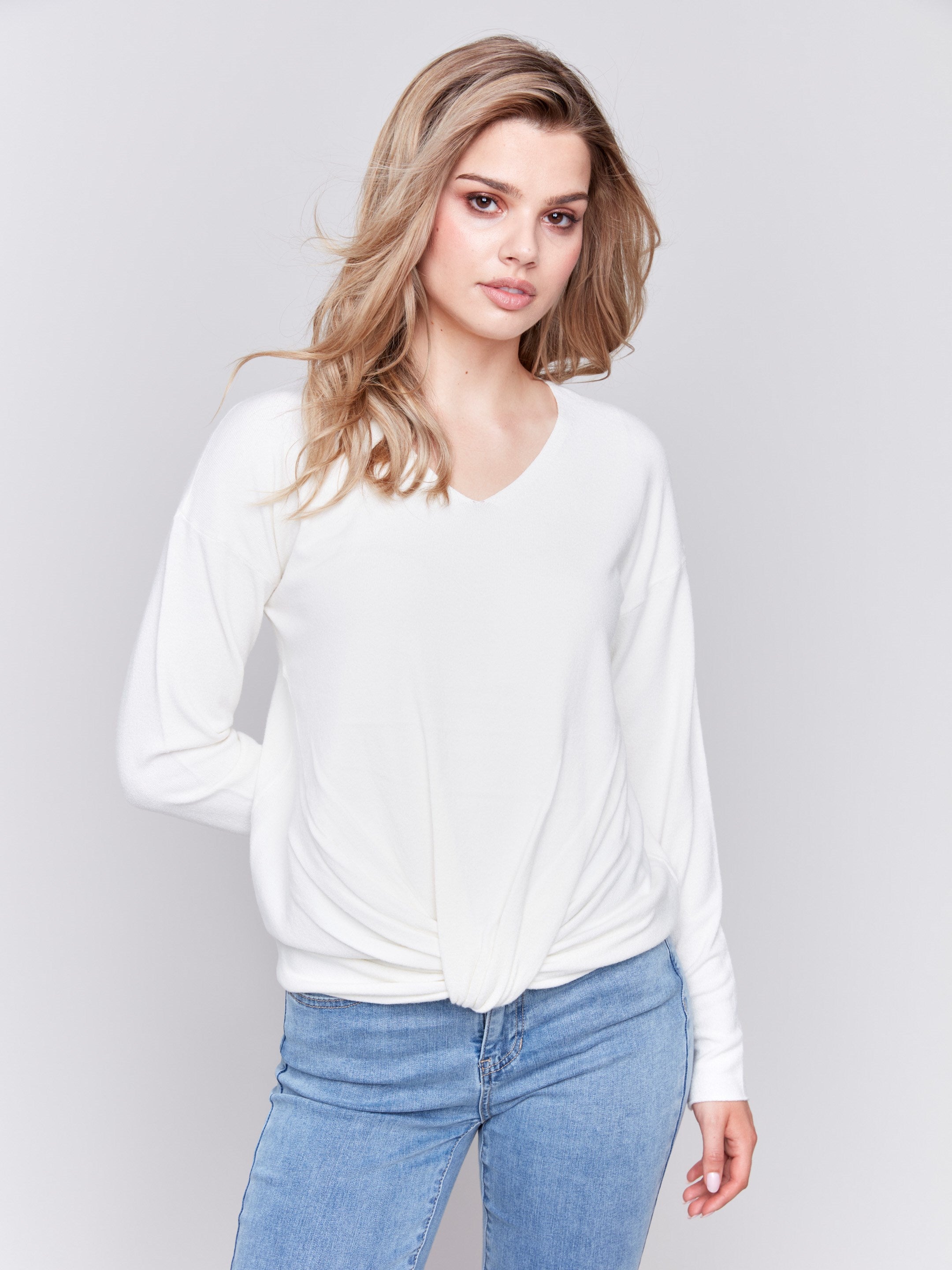 Ecru white long-sleeve sweater with front knot detail and V-neckline by Charlie B.