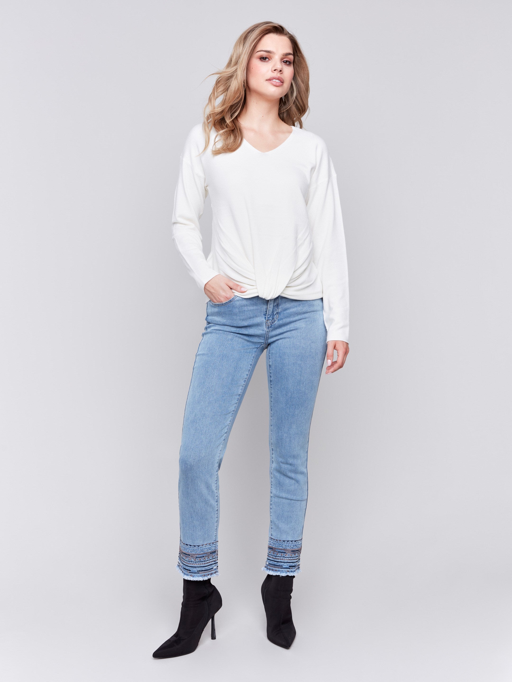 Ecru white long-sleeve sweater with front knot detail and V-neckline by Charlie B.