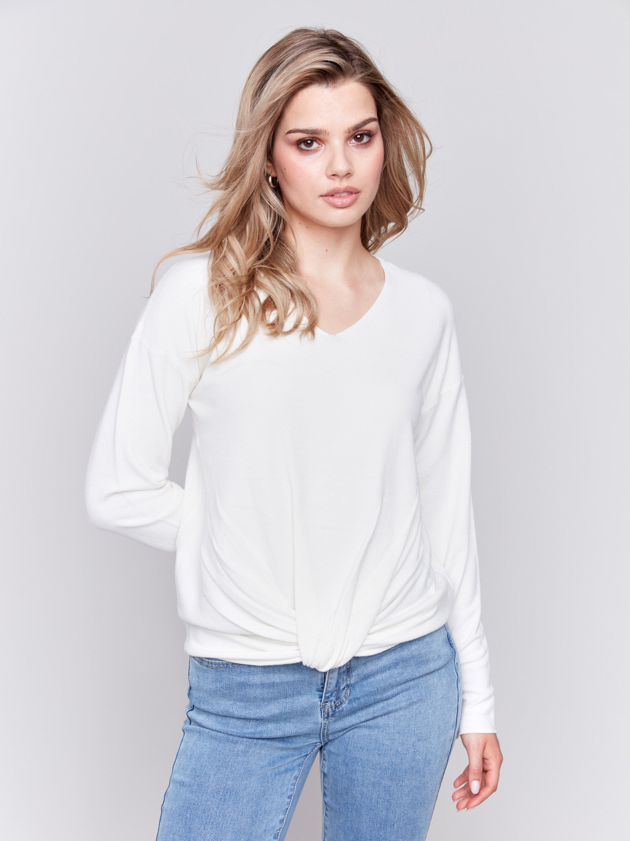 Ecru white long-sleeve sweater with front knot detail and V-neckline by Charlie B.