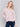 Light pink long-sleeve sweater with front knot detail and V-neckline by Charlie B.