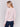 Light pink long-sleeve sweater with front knot detail and V-neckline by Charlie B.