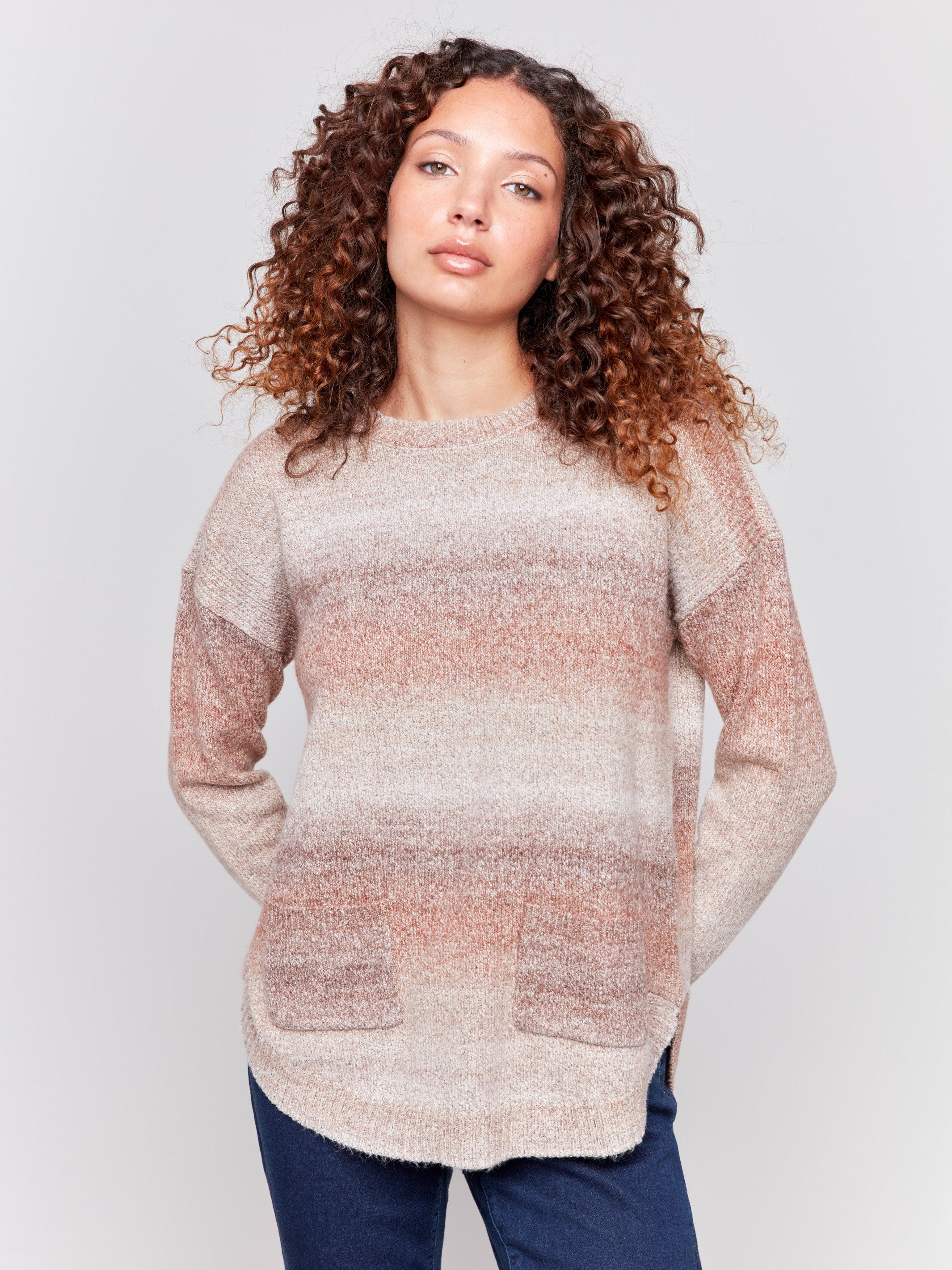 Sweater with removable scarf in a striped Timber print has a round hem and front pockets. Charlie B.