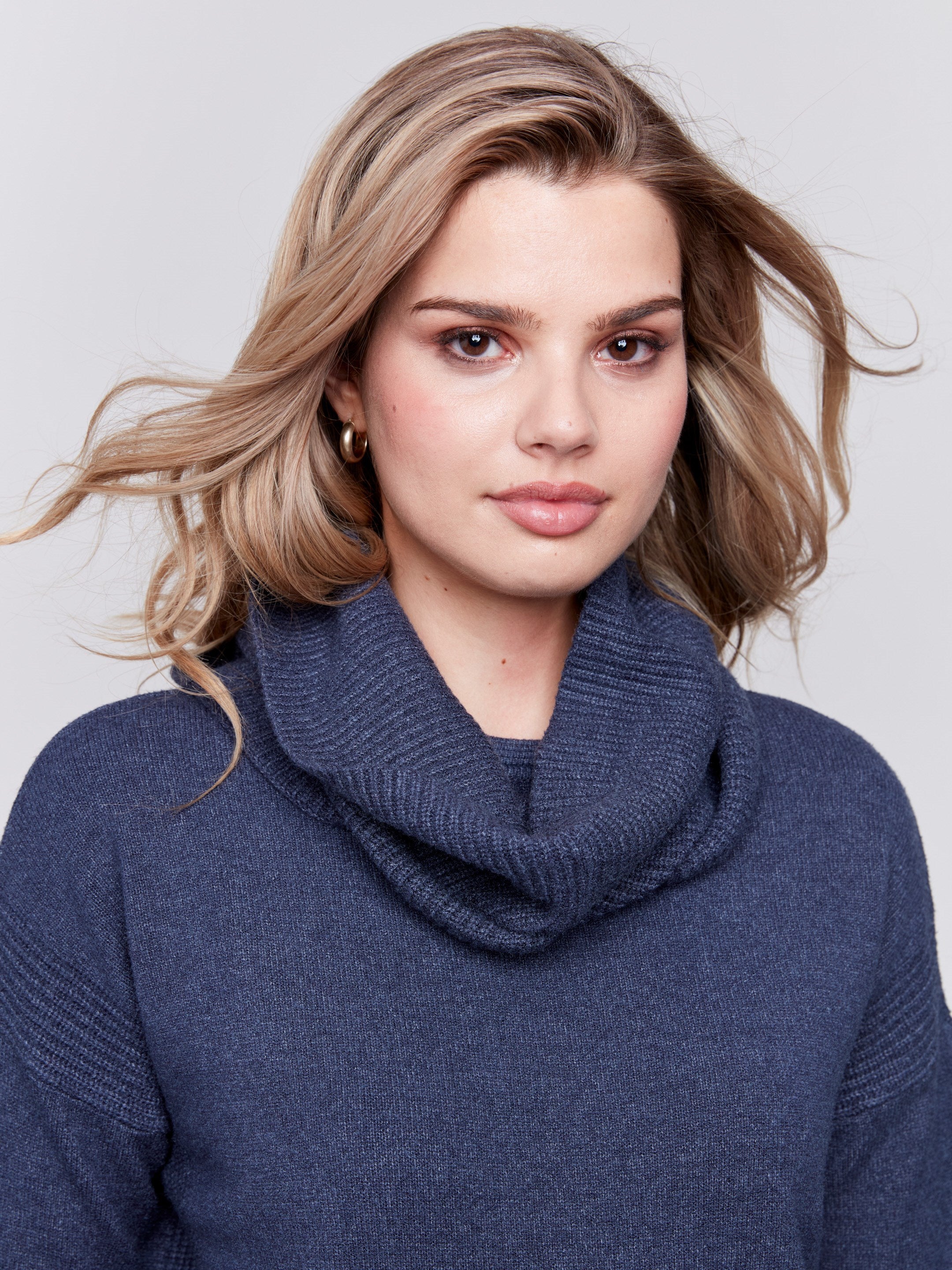 Dark blue round hem sweater with a removable scarf and front pockets by Charlie B.