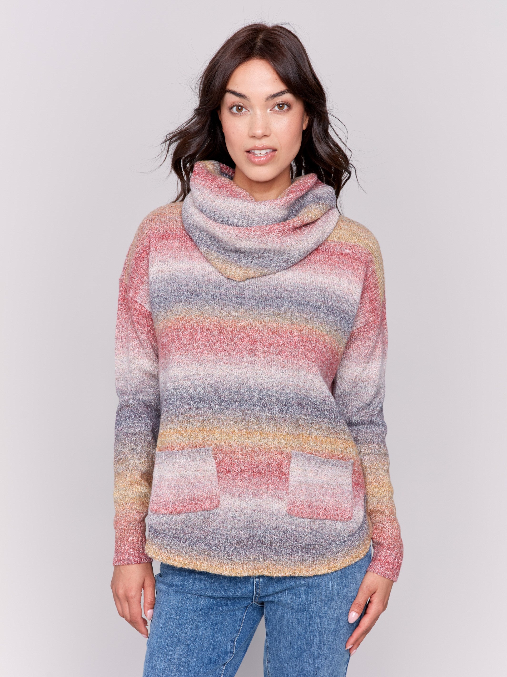 Sweater with removable scarf in a striped pink print has a round hem and front pockets. Charlie B.