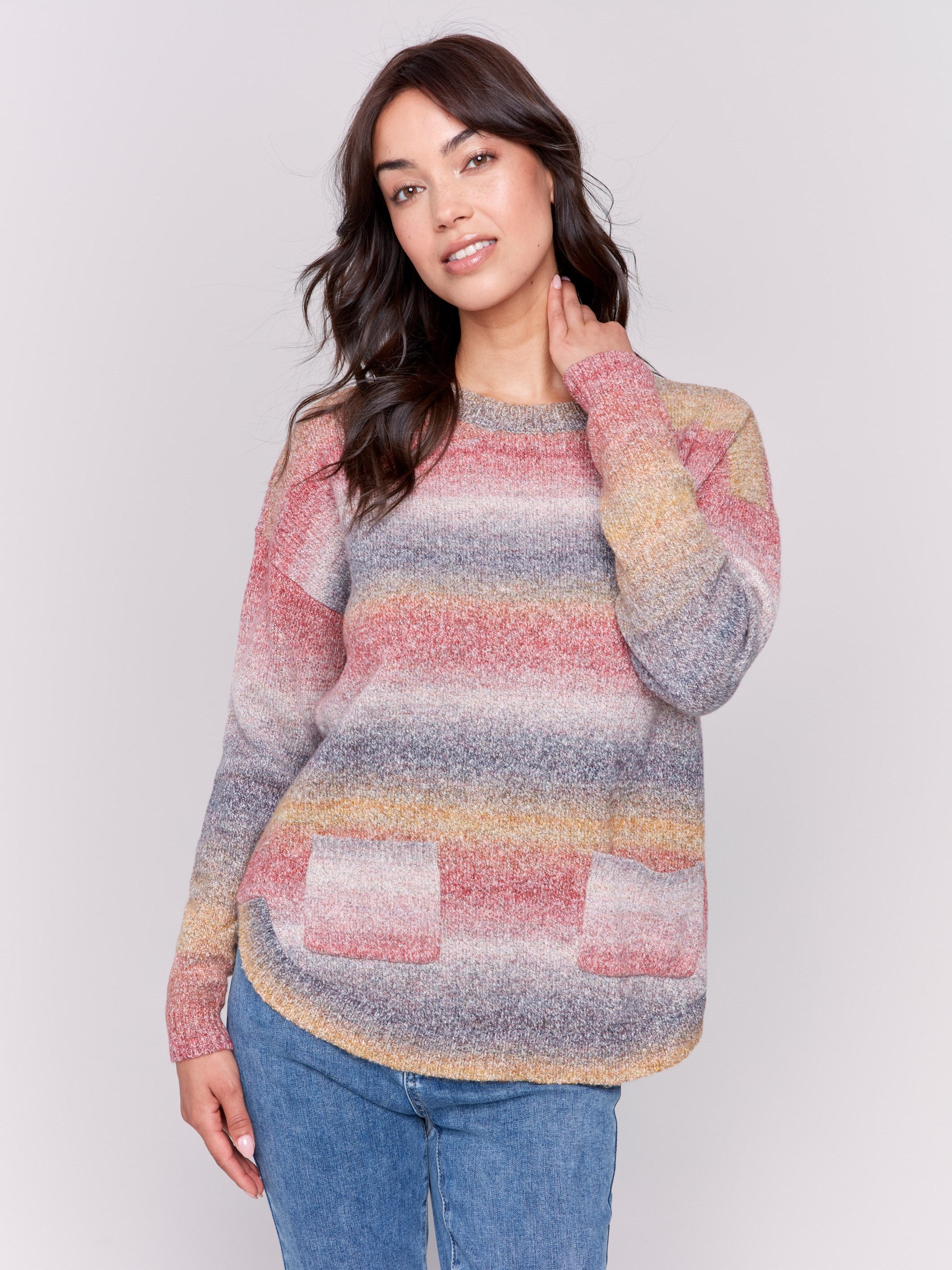 Sweater with removable scarf in a striped pink print has a round hem and front pockets. Charlie B.